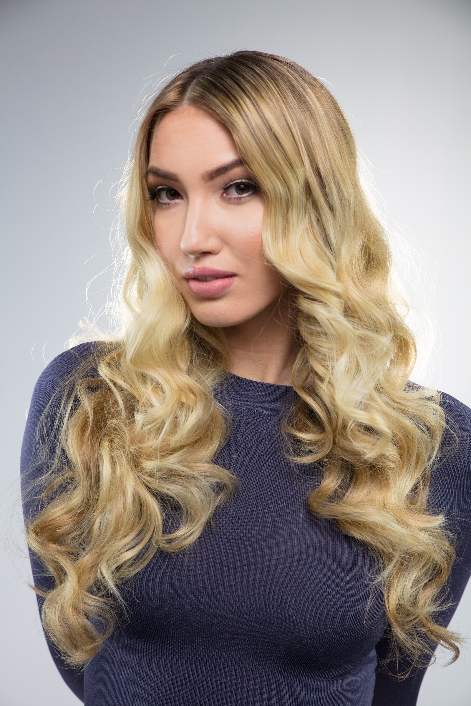 Close beauty portrait highlighting long blonde curls.