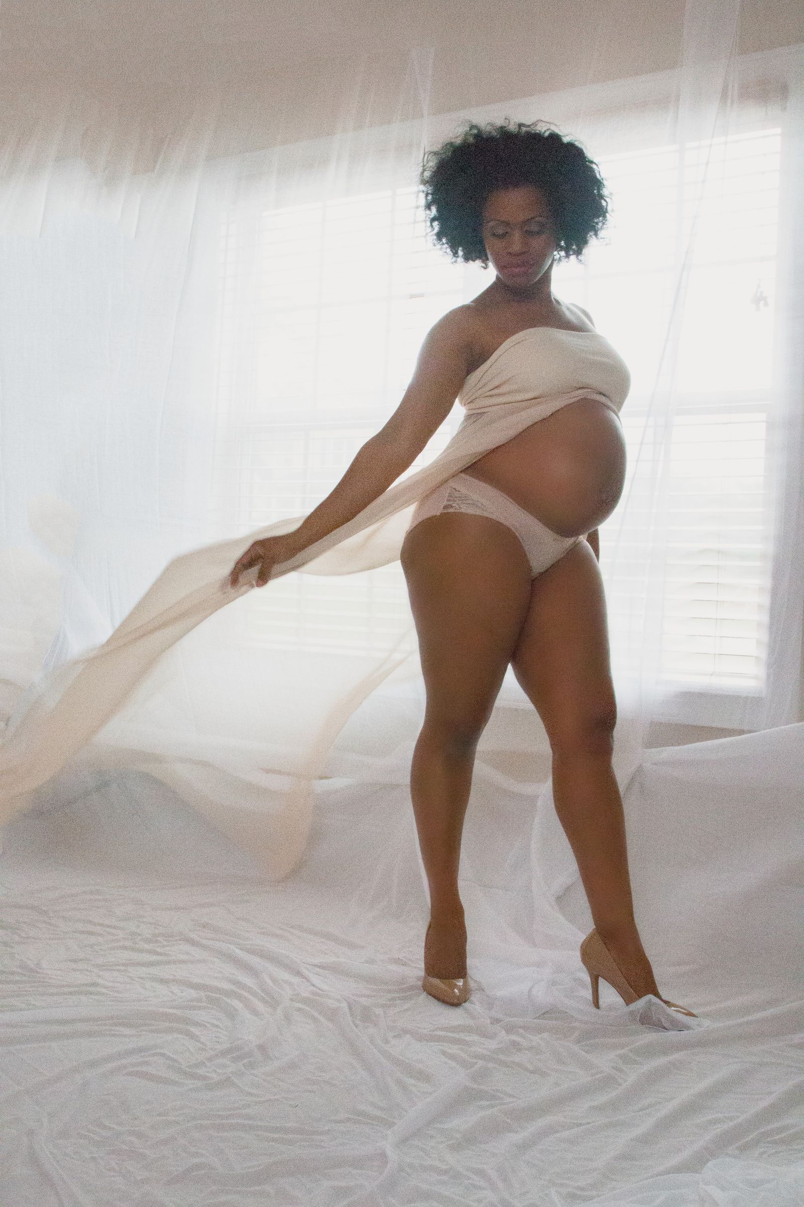 At-home maternity portrait photographed by ART Studios