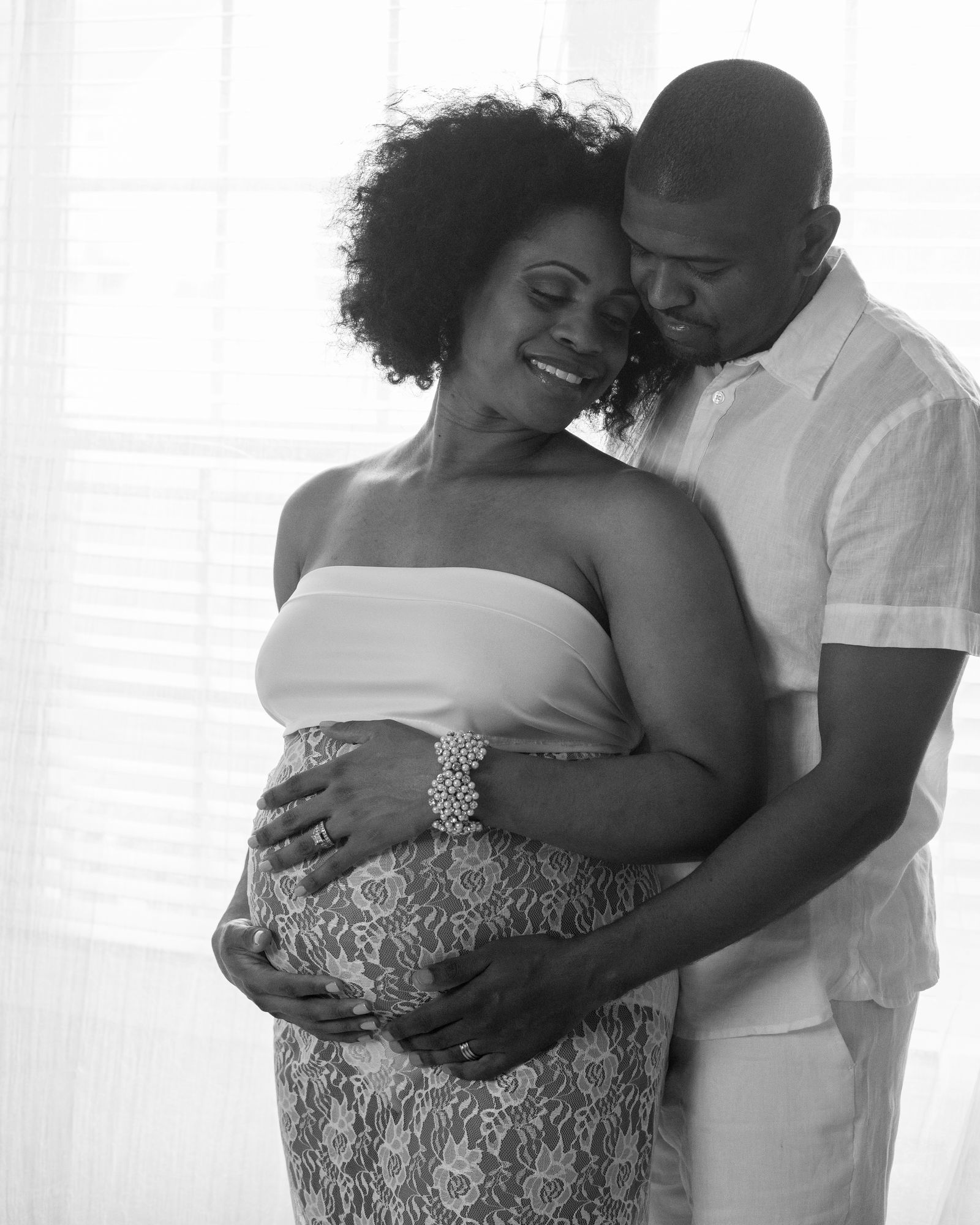 At-home maternity portrait photographed by ART Studios