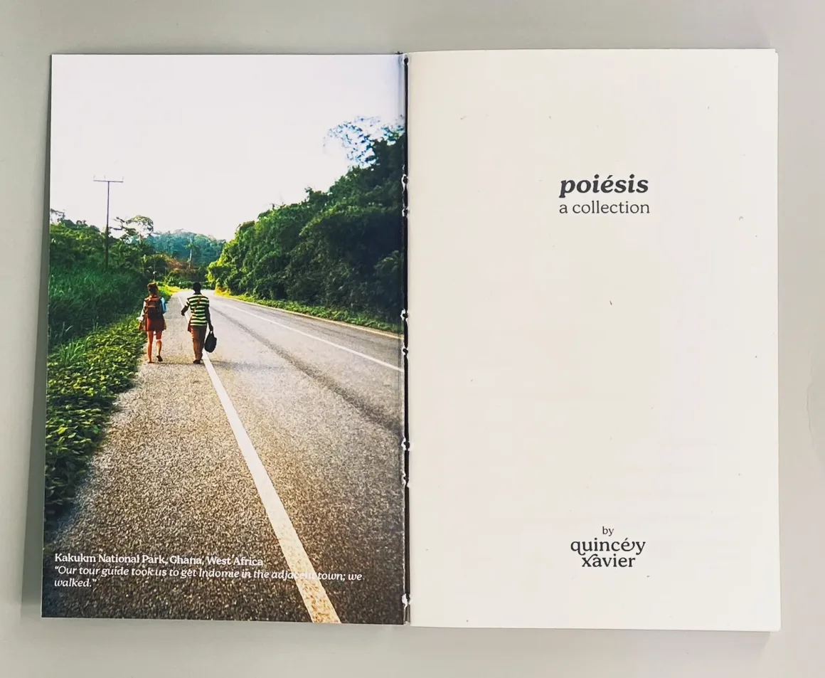 the book open to its title page. on the left, a photograph of two people walking down a road between green hills.