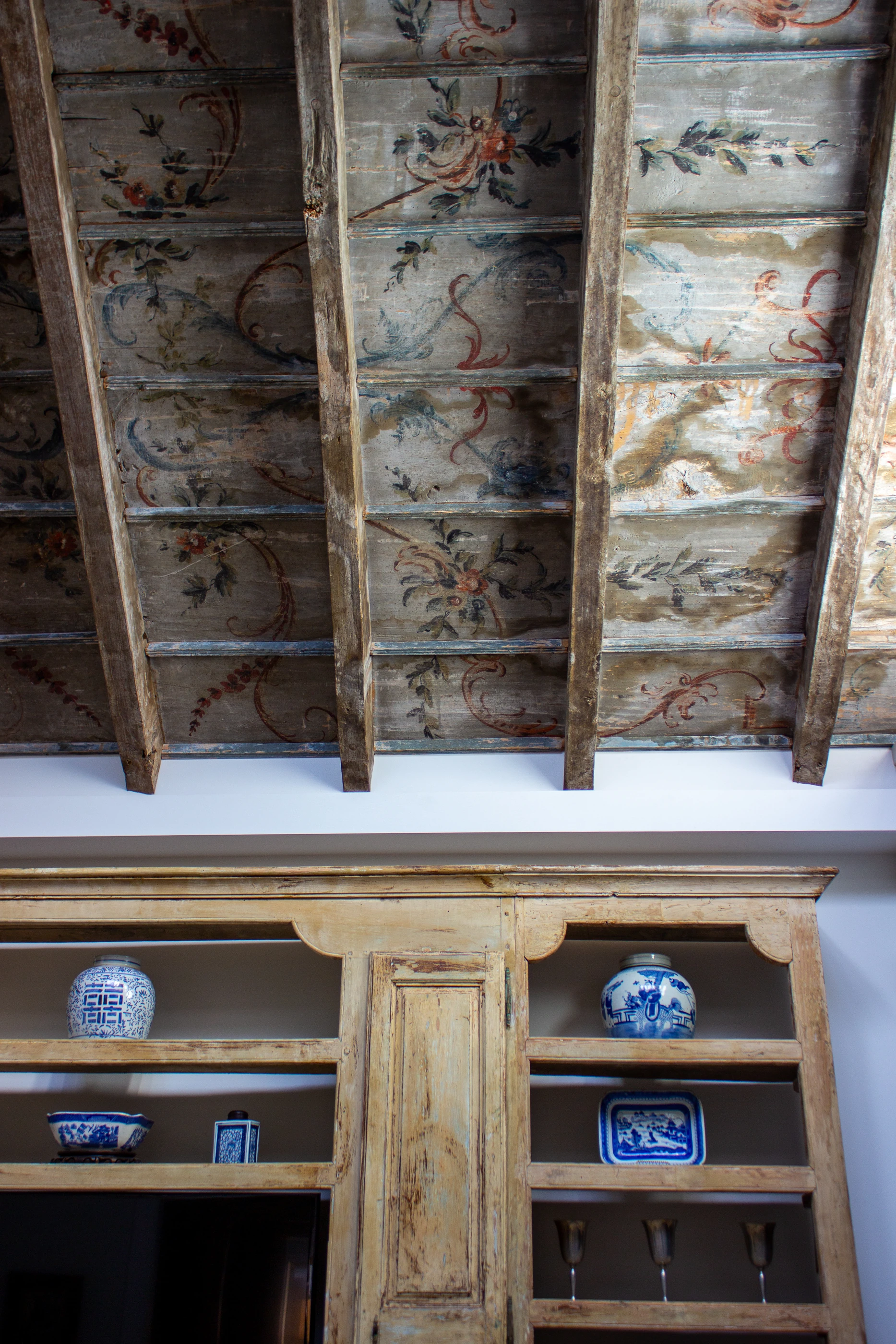 Jessamine County Farm painted ceiling with birds, branches and carved timber cabinetry.