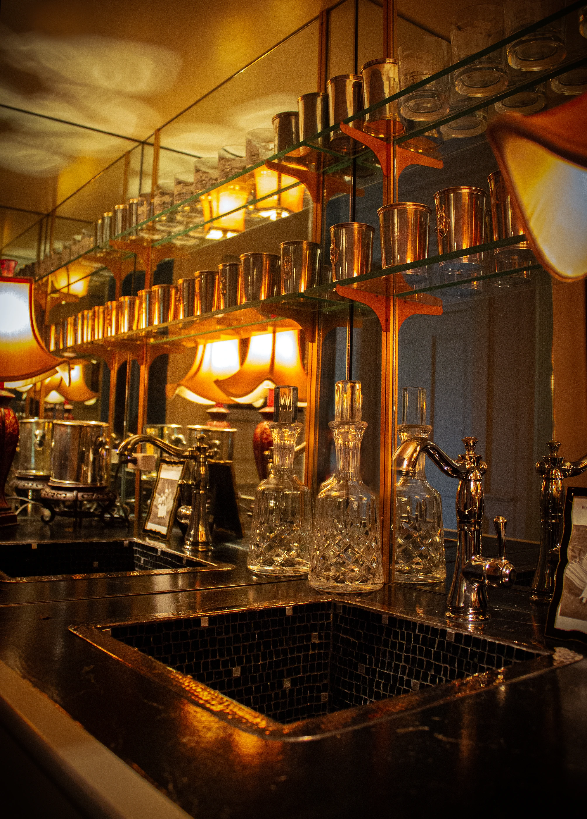 Ashland Park bar with crystal glassware, mirrored shelves and warm brass details.