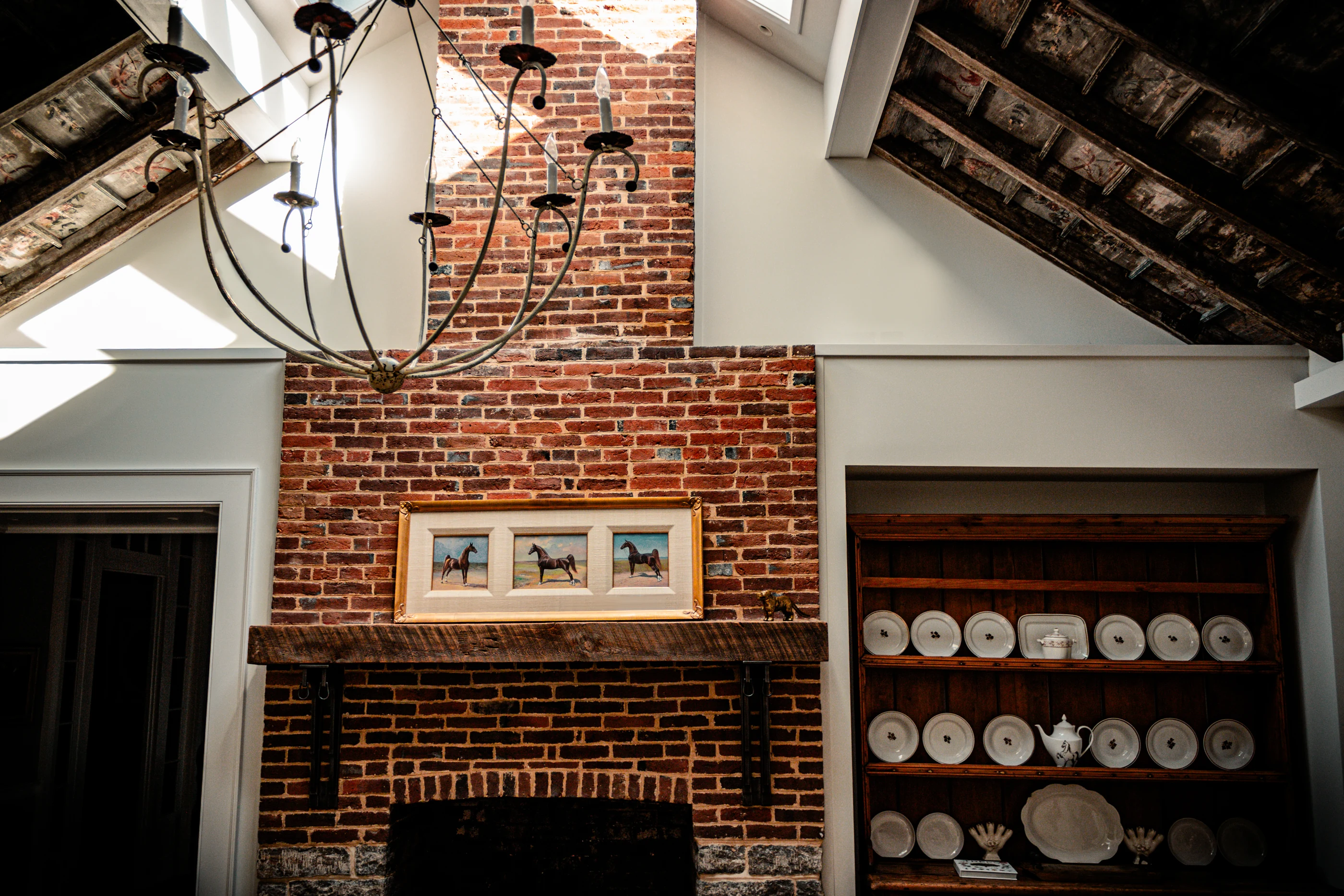 Jessamine County Farm breakfast room with a brick fireplace, painted ceiling and antique dressers.