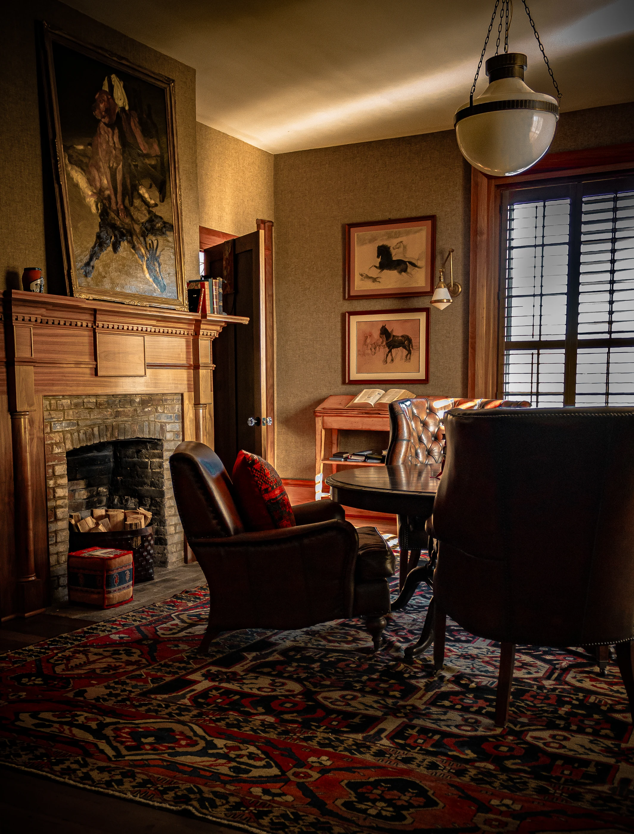 Library fireplace and leather seating at Equestrian Estate.