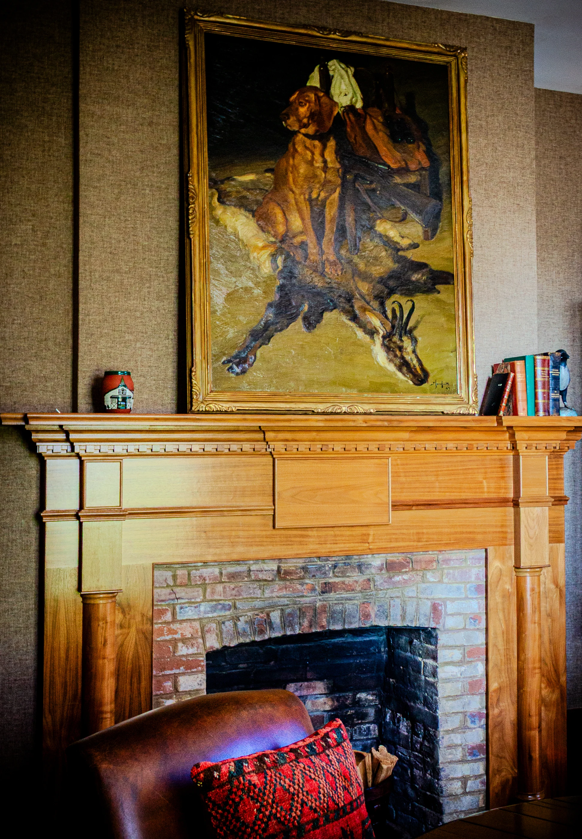 Equestrian artwork above the timber mantel at Equestrian Estate.