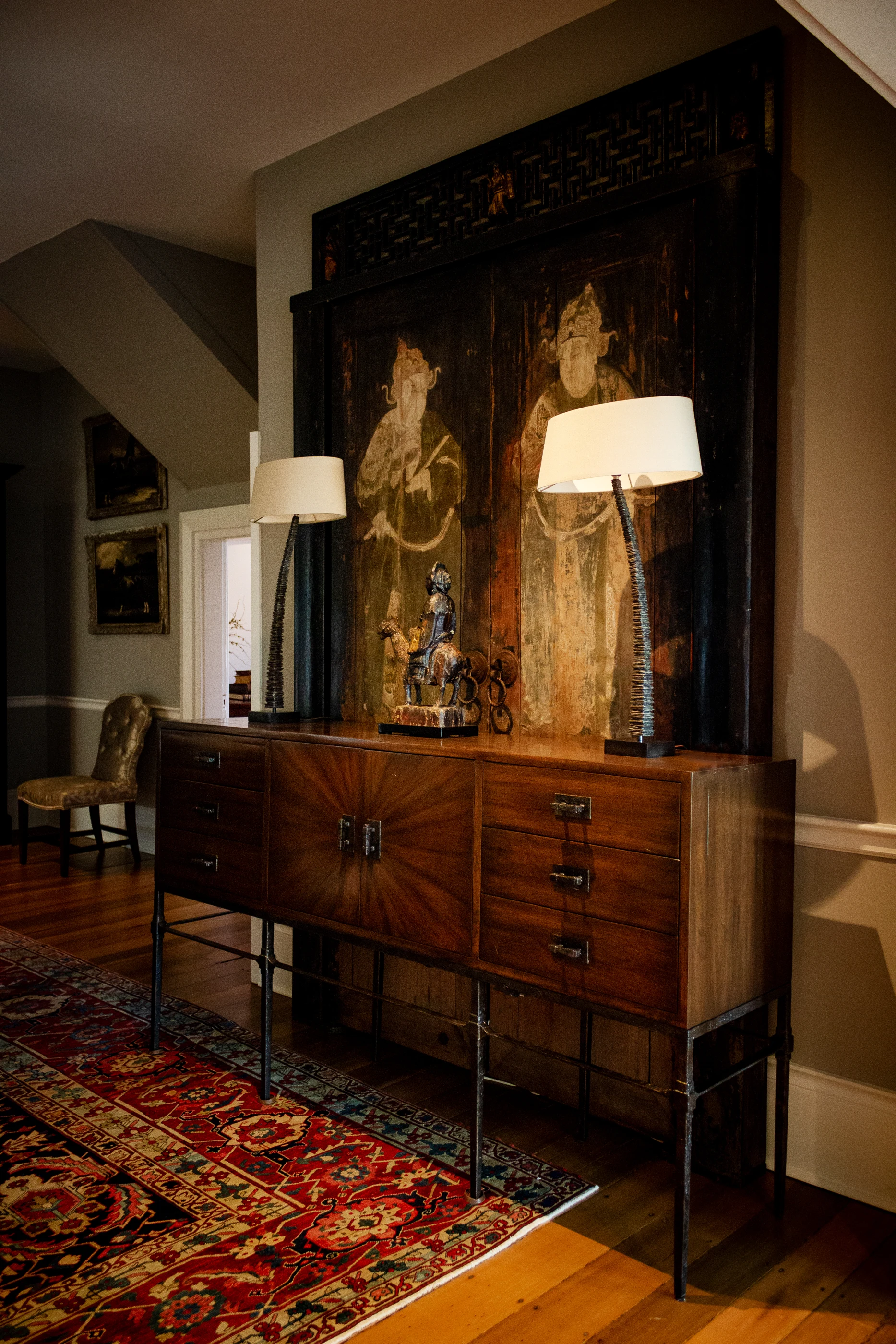 Antique sideboard beneath a tapestry at Equestrian Estate.