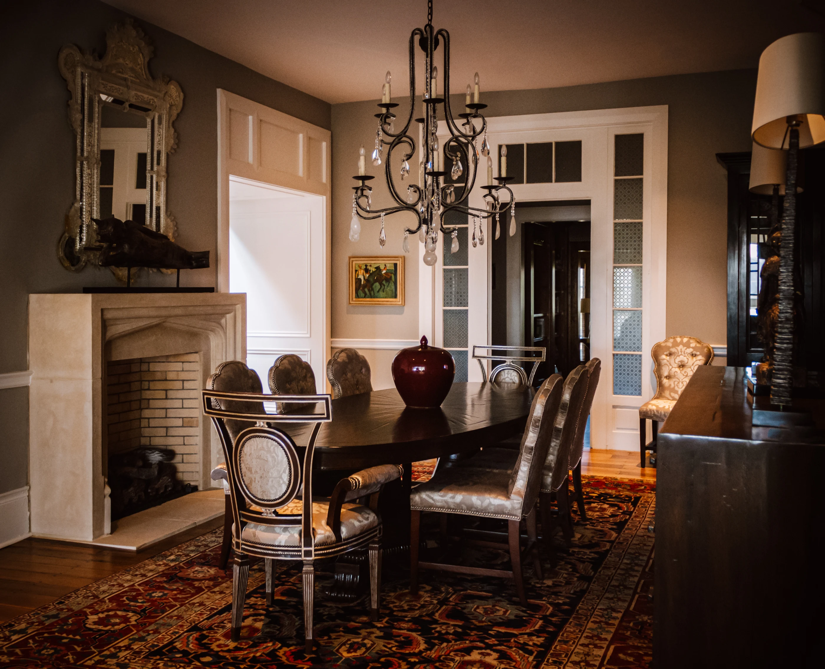 Dining room with crystal chandelier and collected furnishings at Equestrian Estate.