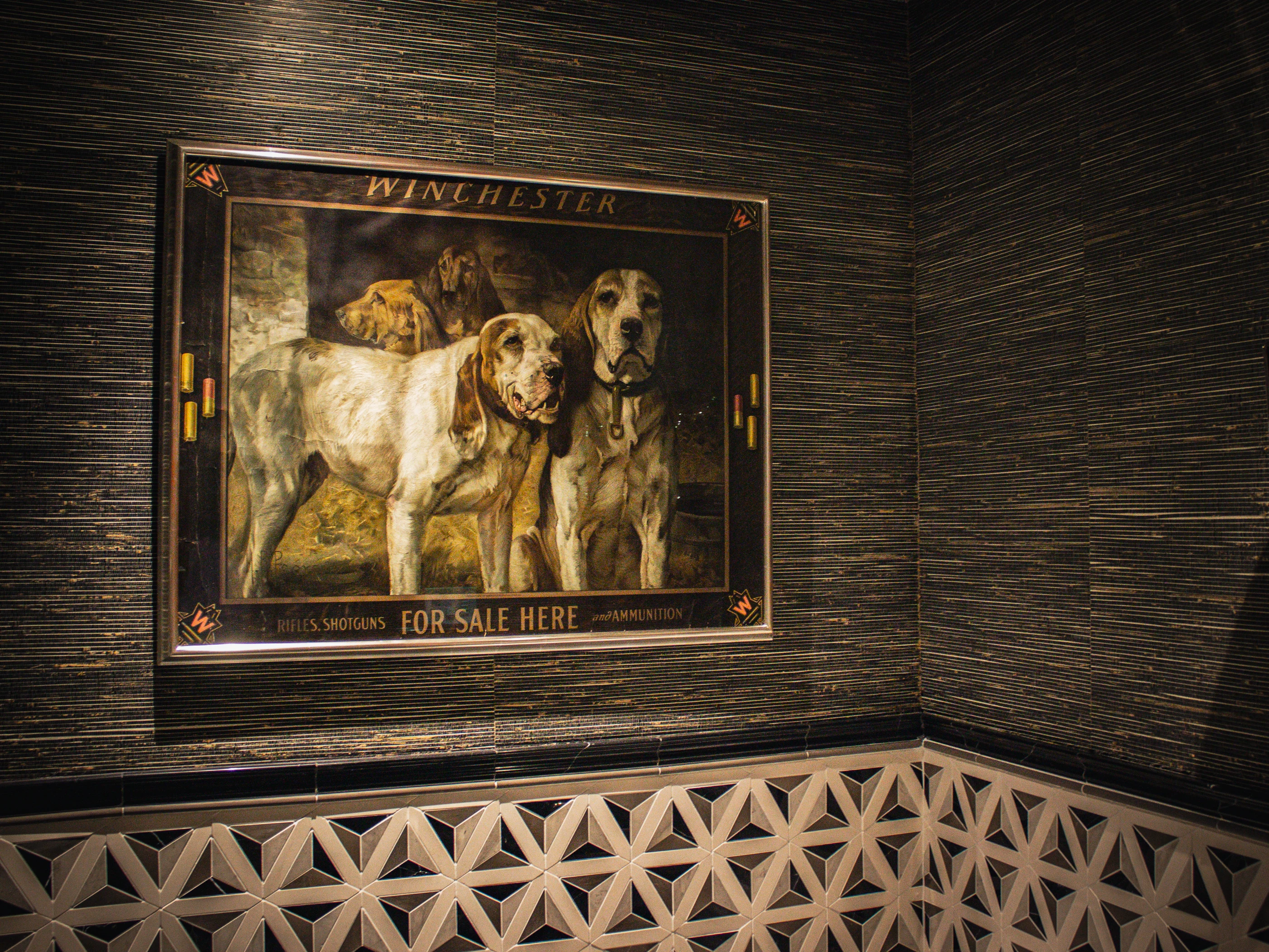 Equestrian artwork above geometric wall tile at Equestrian Estate.