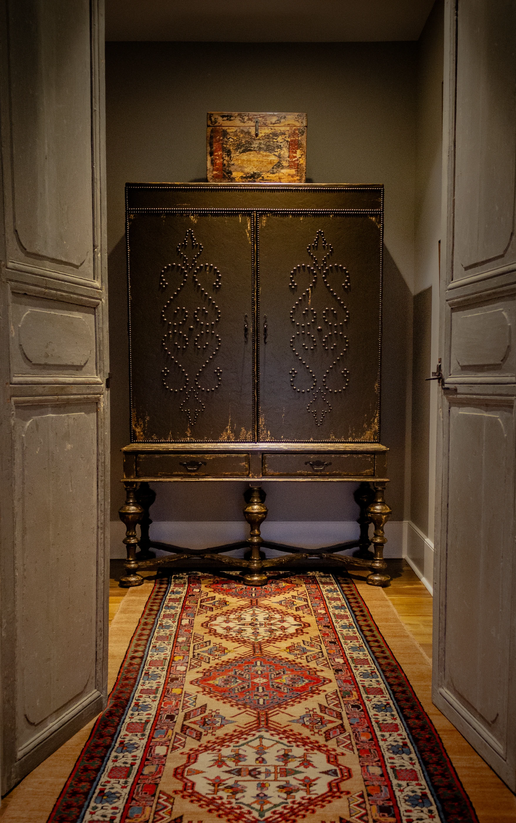 Decorative antique cabinet at the end of a hallway at Equestrian Estate.