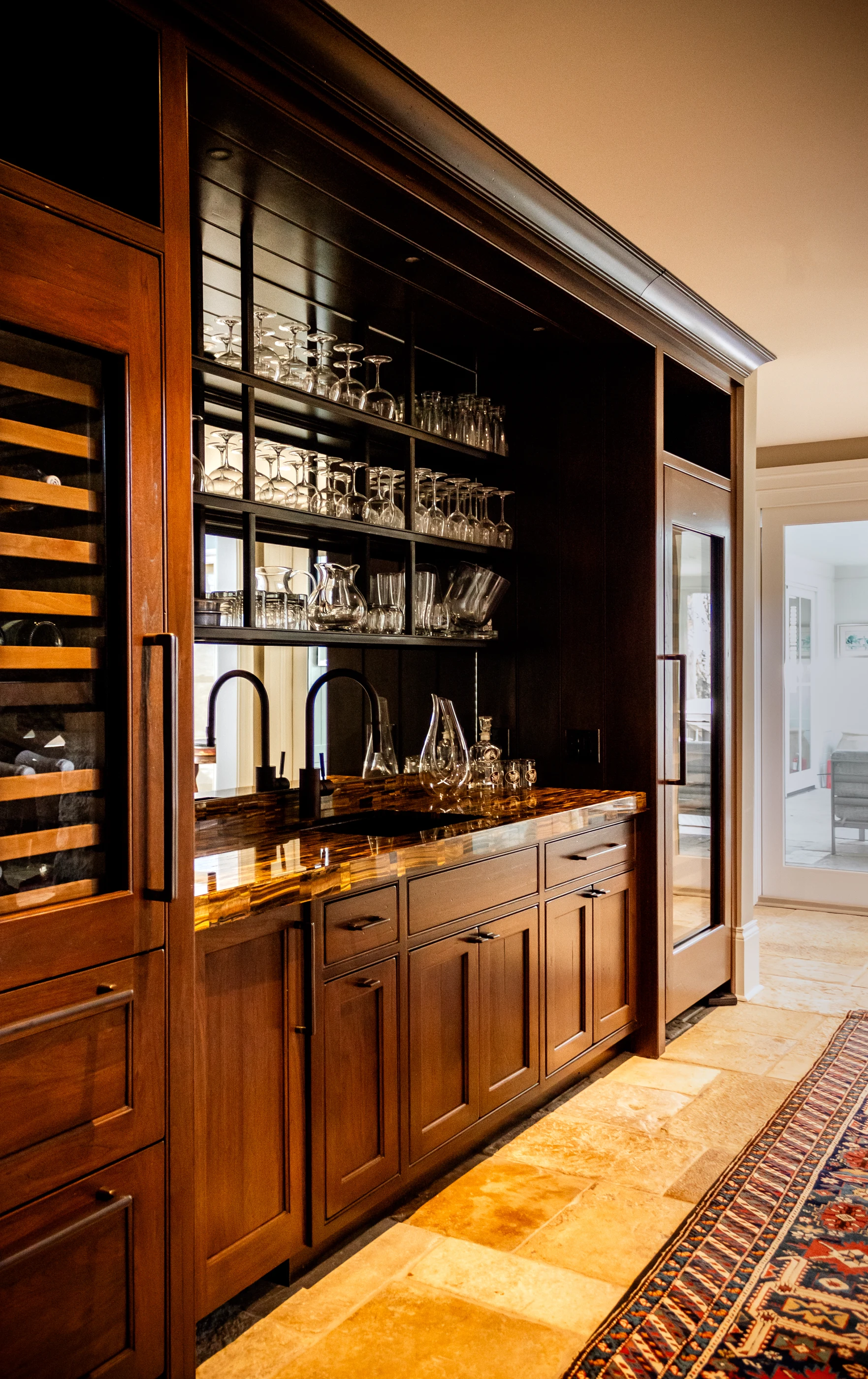 Timber wine bar with glassware and stone counter at Equestrian Estate.