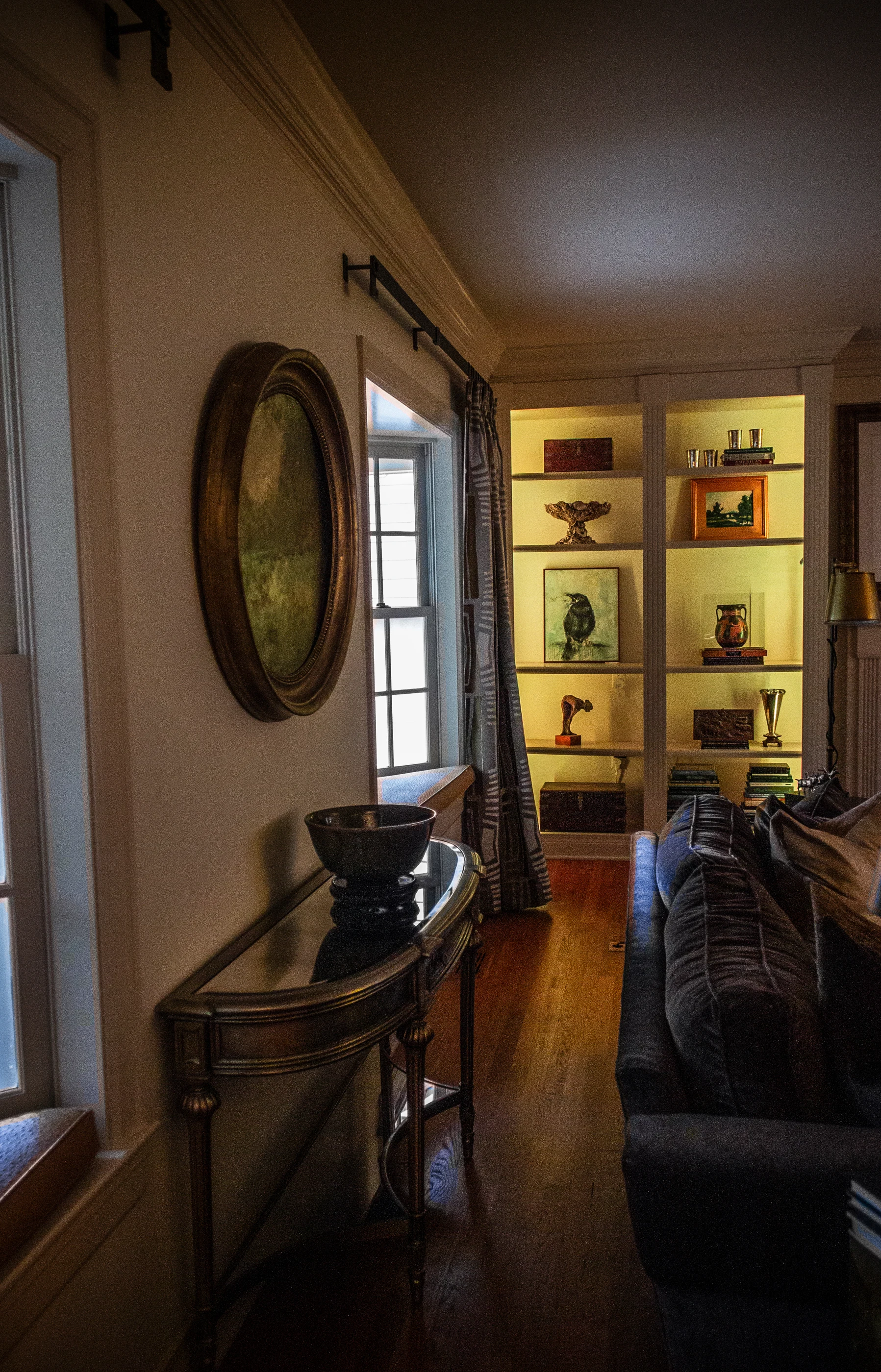 Layered living room with antique console and collected pieces at Ashland Park.