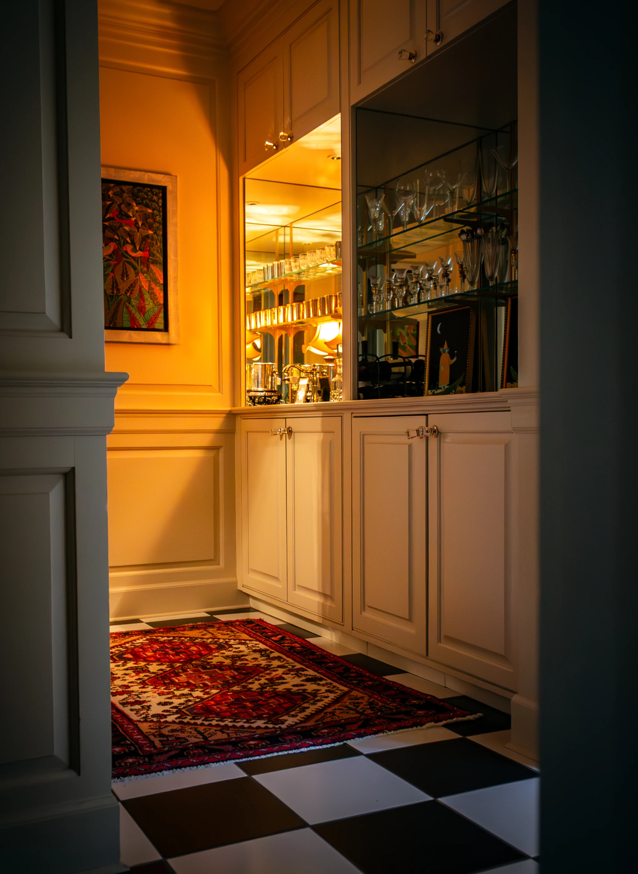 Bar cabinetry and glassware framed by a doorway at Ashland Park.