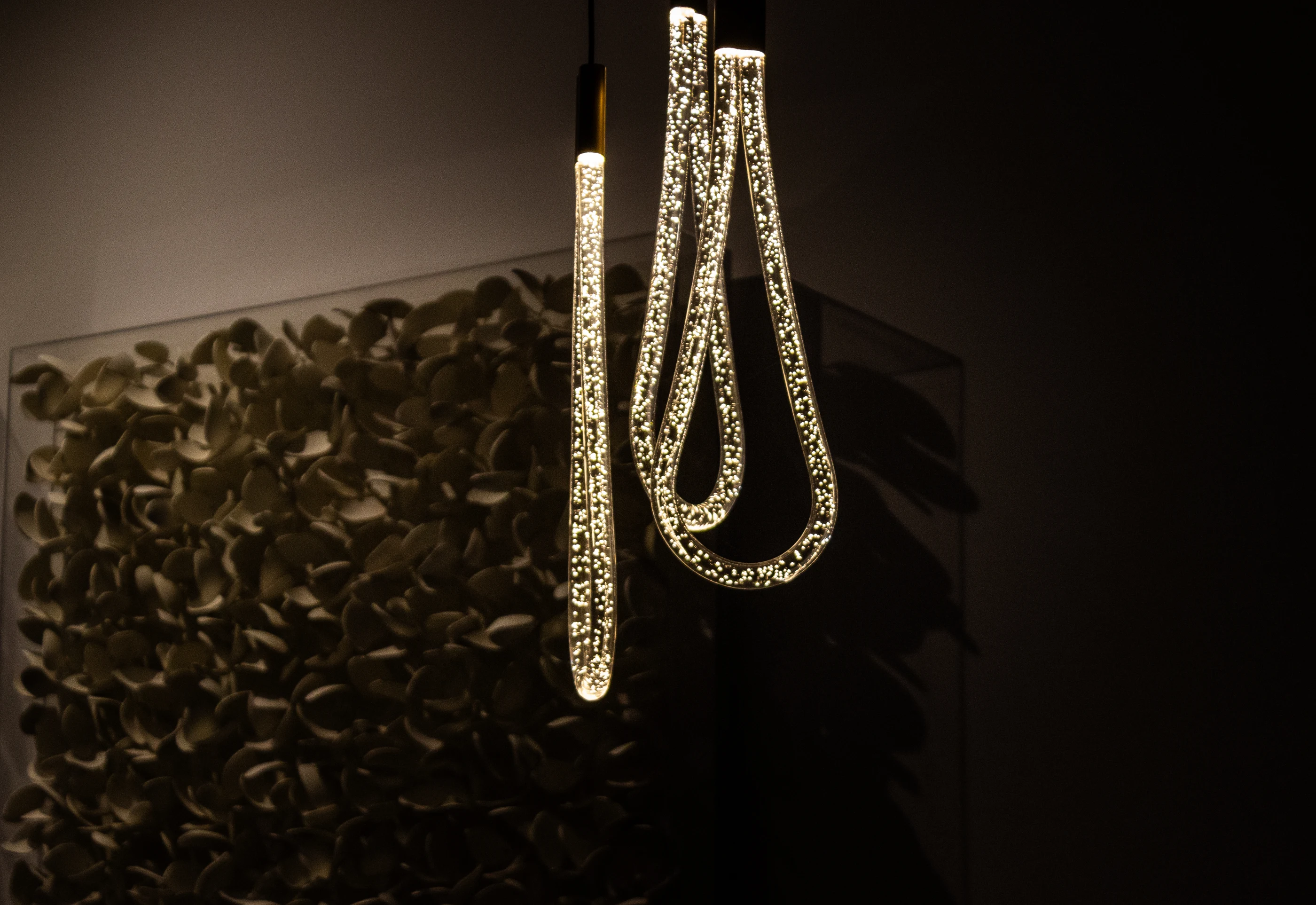 Looped pendant beside dimensional wall sculpture at Urban Mod.
