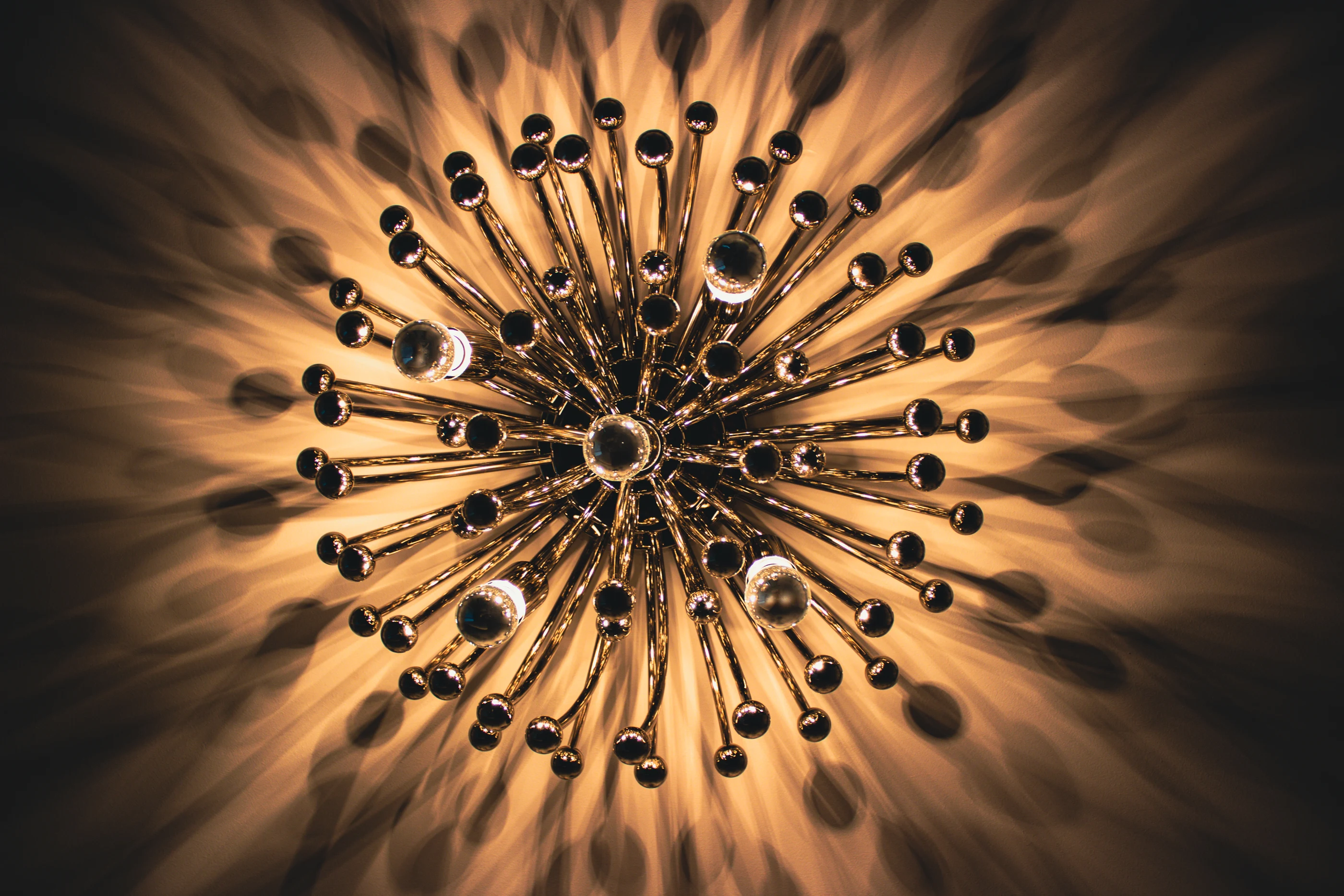 Radiating wall light casting patterned shadows at Urban Mod.