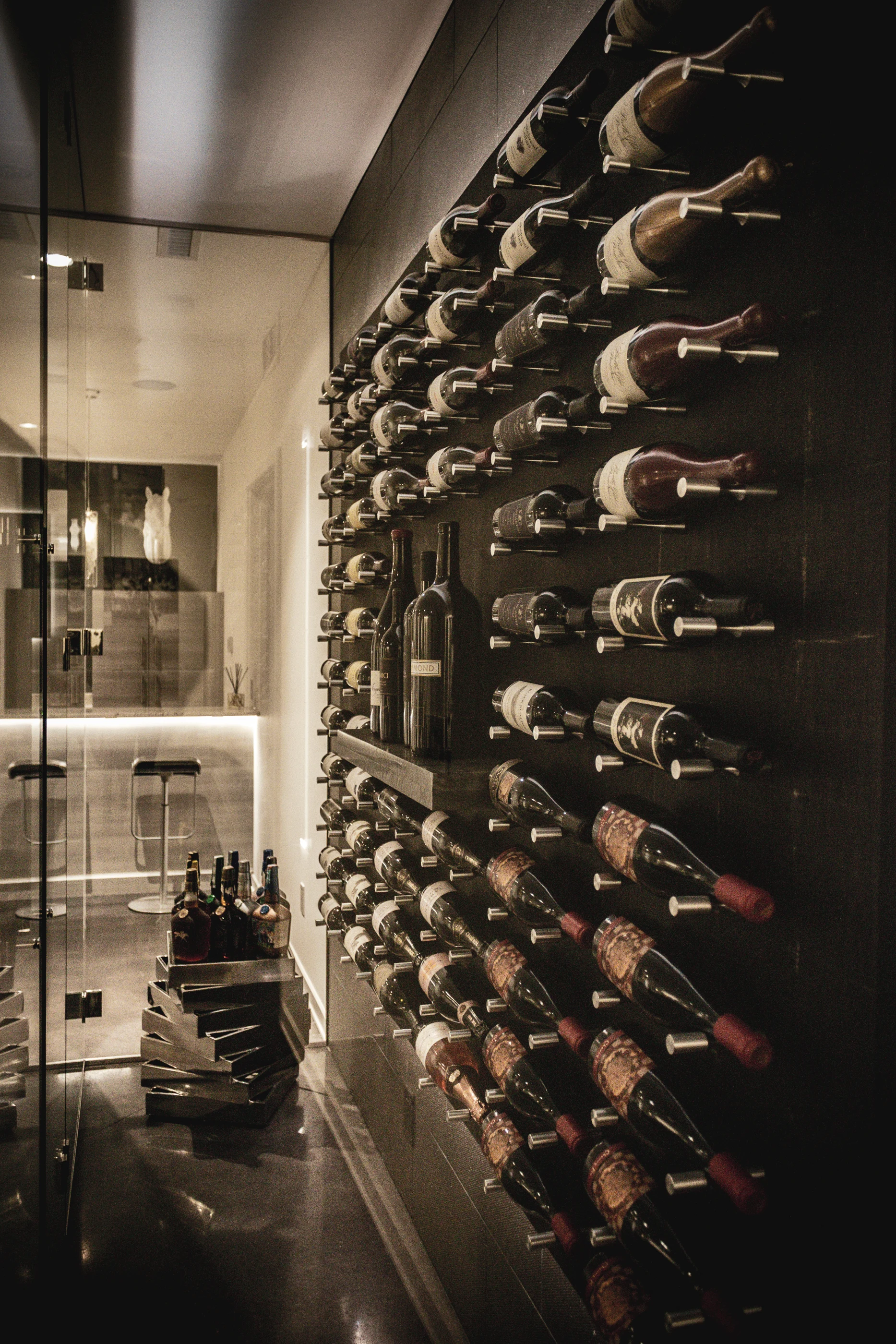 Wall-mounted wine collection behind glass at Urban Mod.