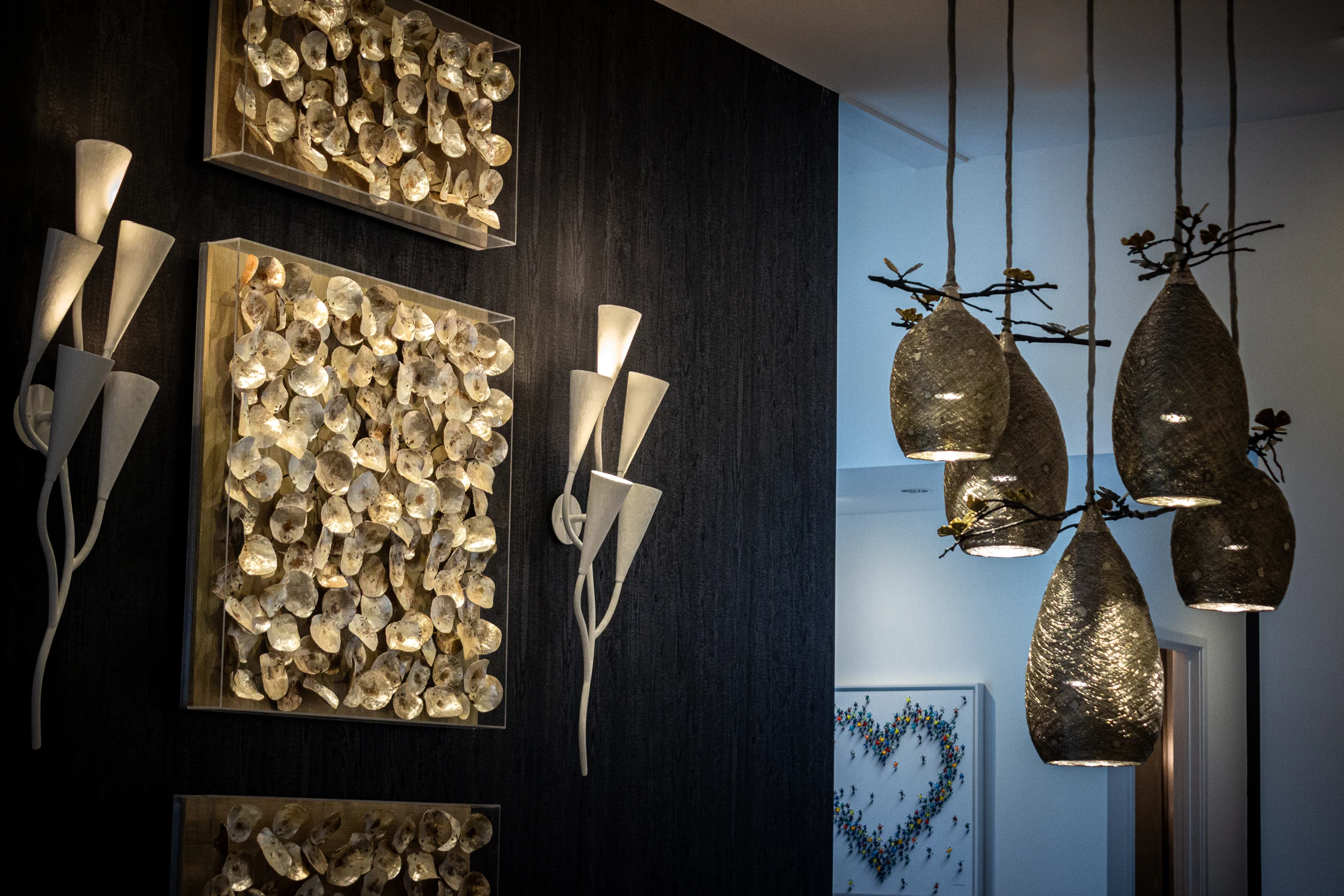Dimensional wall art beside clustered pendants at Urban Mod.