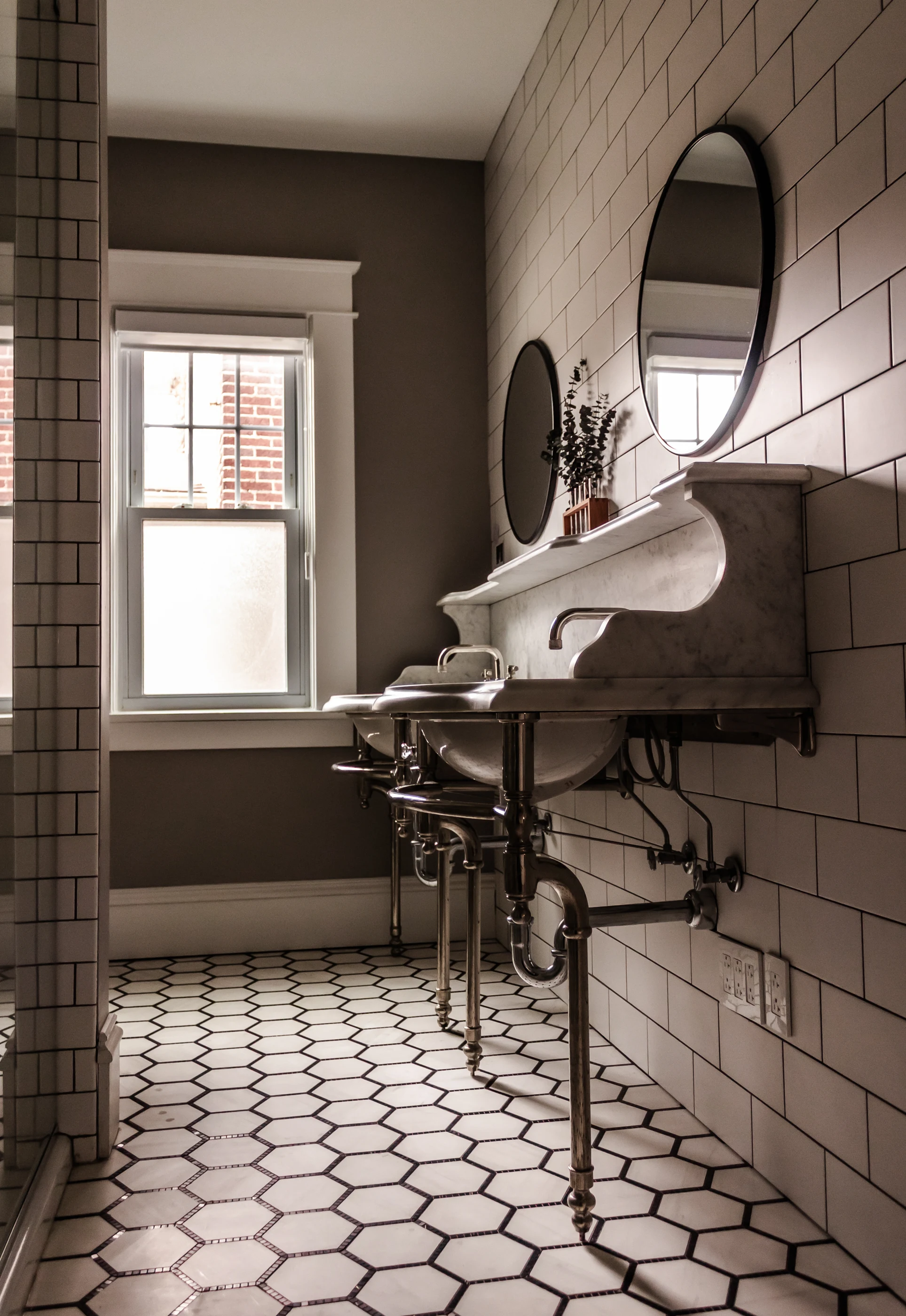 Side view of the stone vanity and polished metal legs at Chevy Chase.