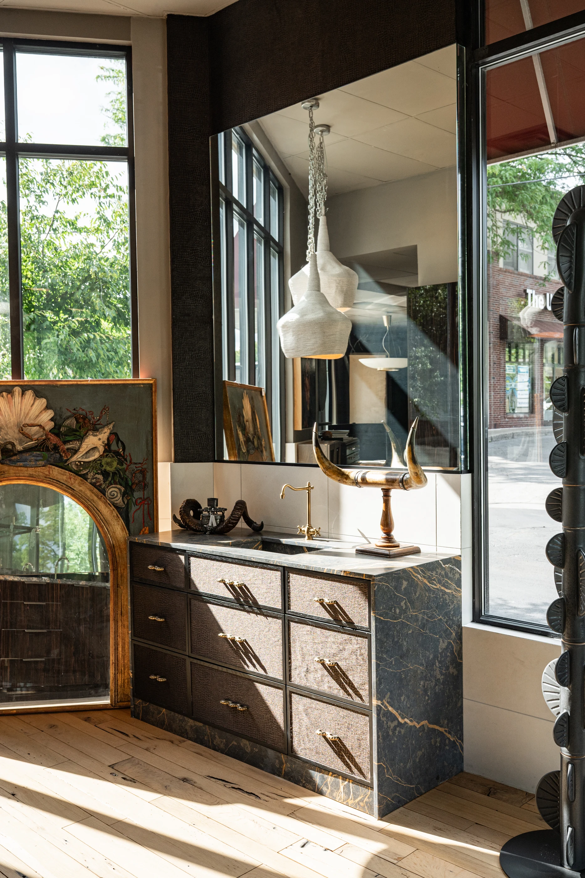 Vanity display illuminated by natural light in the Cabinet & Stone Lab showroom.