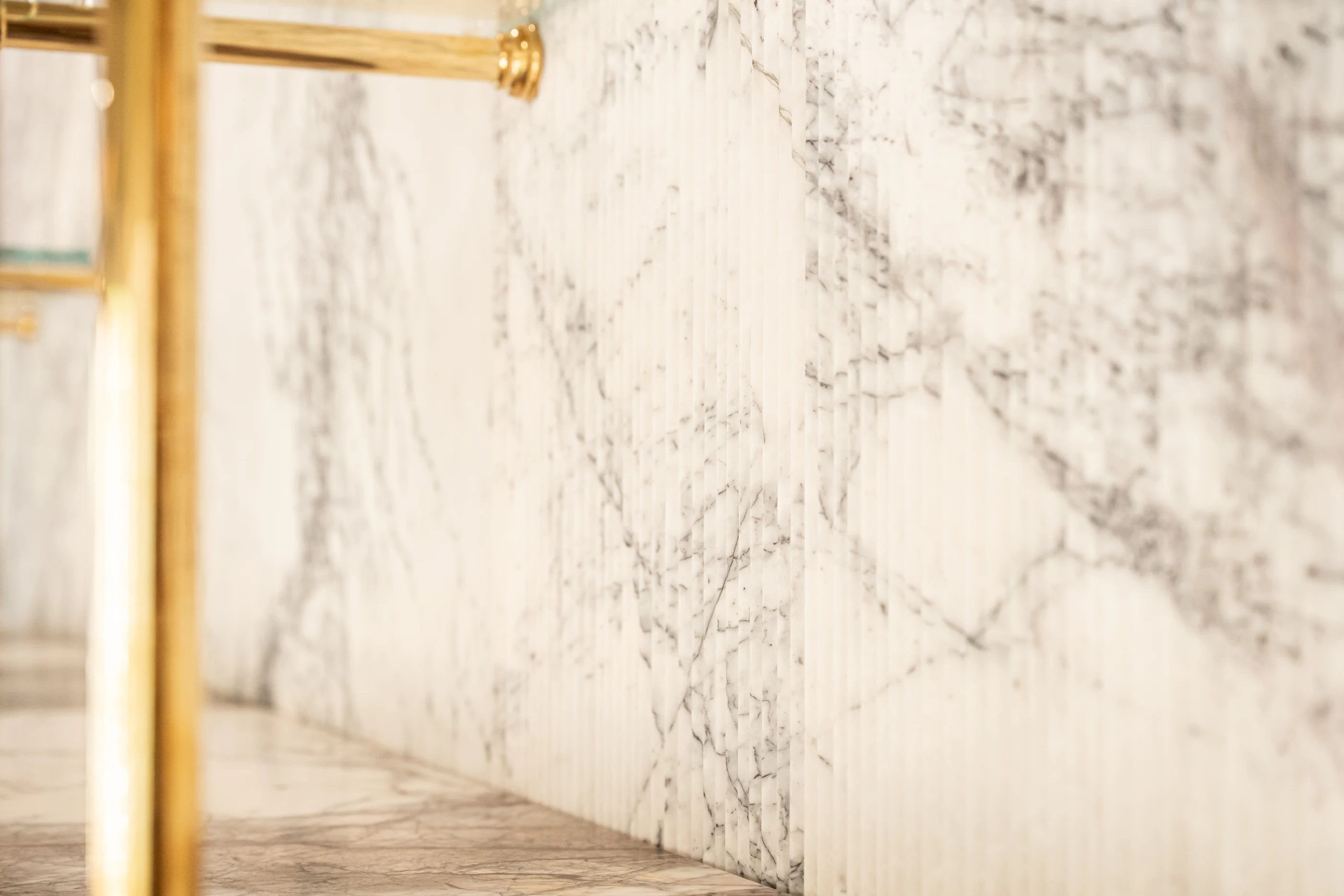 Brass rail and stone shelving detail at Hart Townhouse.