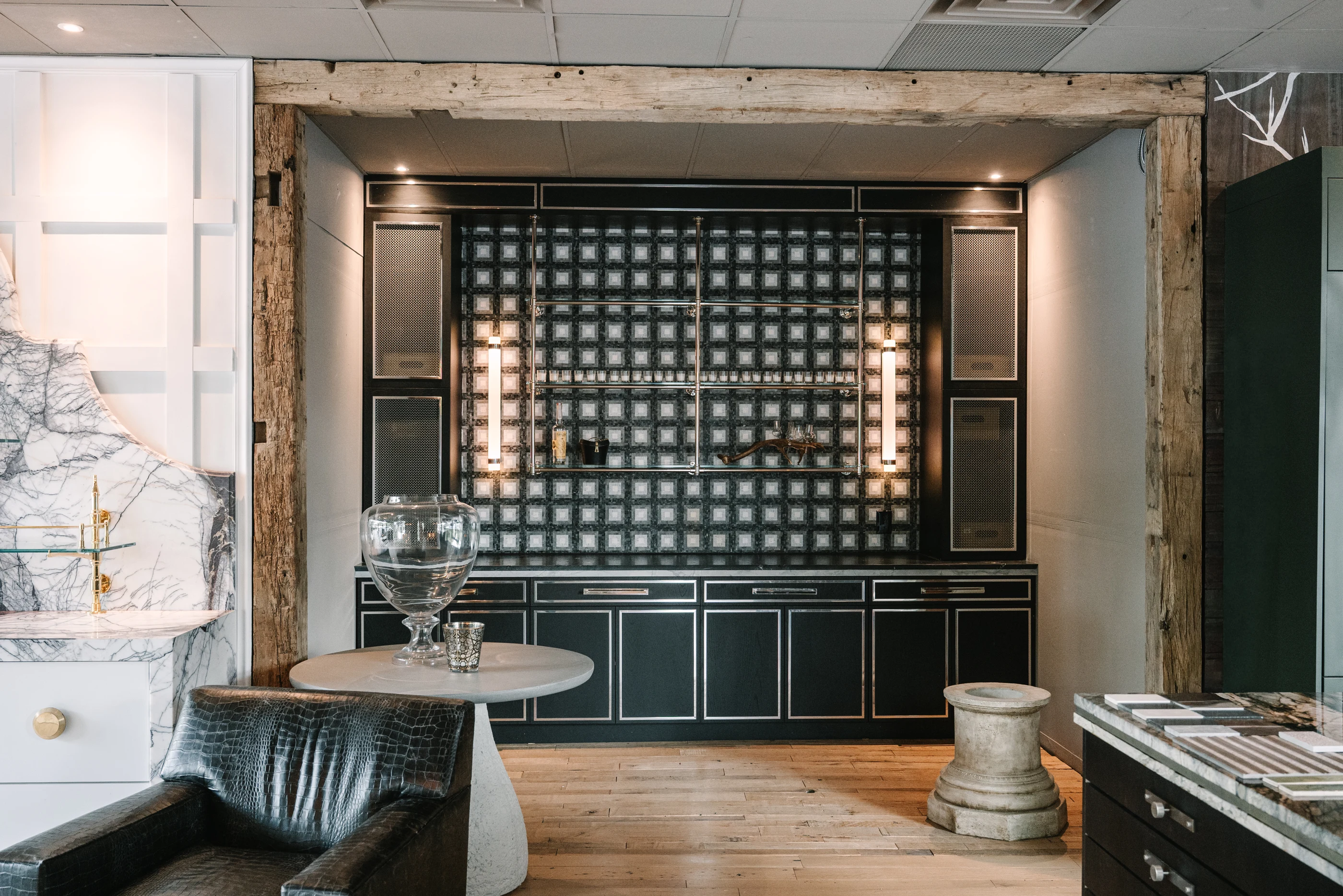 Dark cabinetry, patterned stone and warm display lighting in the Cabinet & Stone Lab showroom.