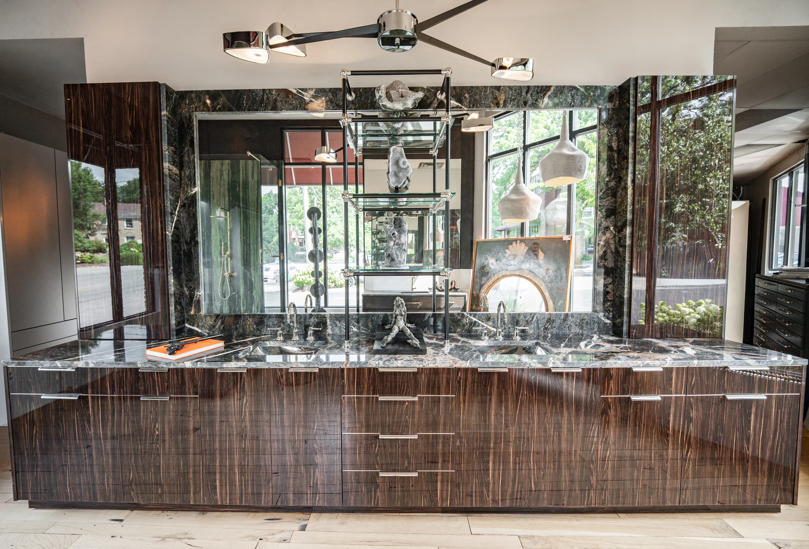 Polished timber cabinetry, mirrored shelving and veined stone in the Cabinet & Stone Lab showroom.