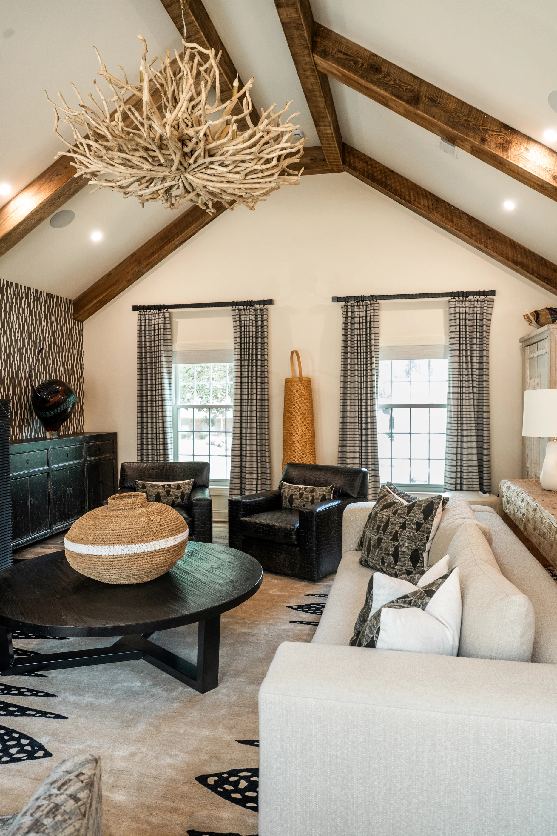 Living room with layered furnishings and timber beams at Hart Townhouse.