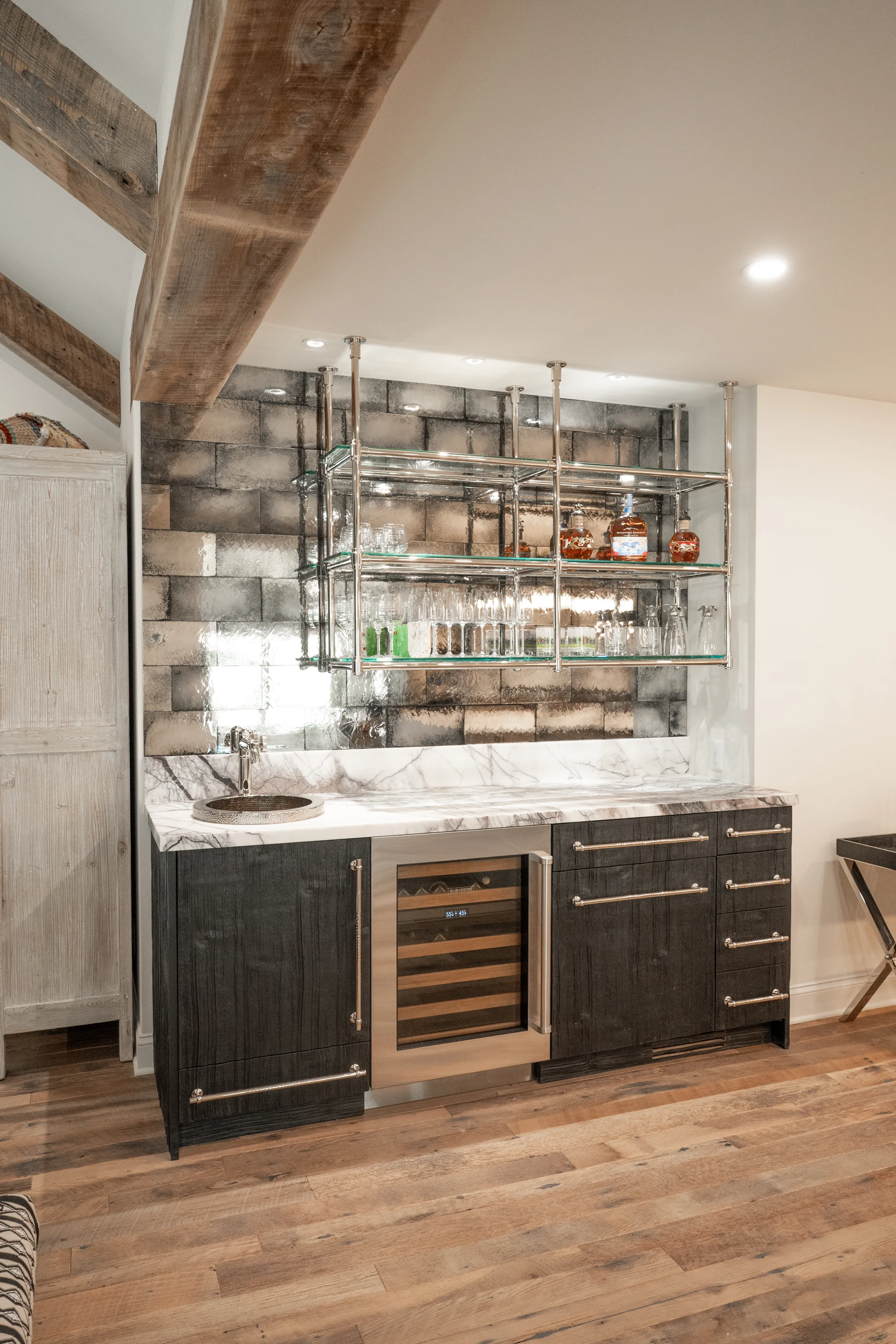 Dark timber bar cabinetry and antique mirror at Hart Townhouse.