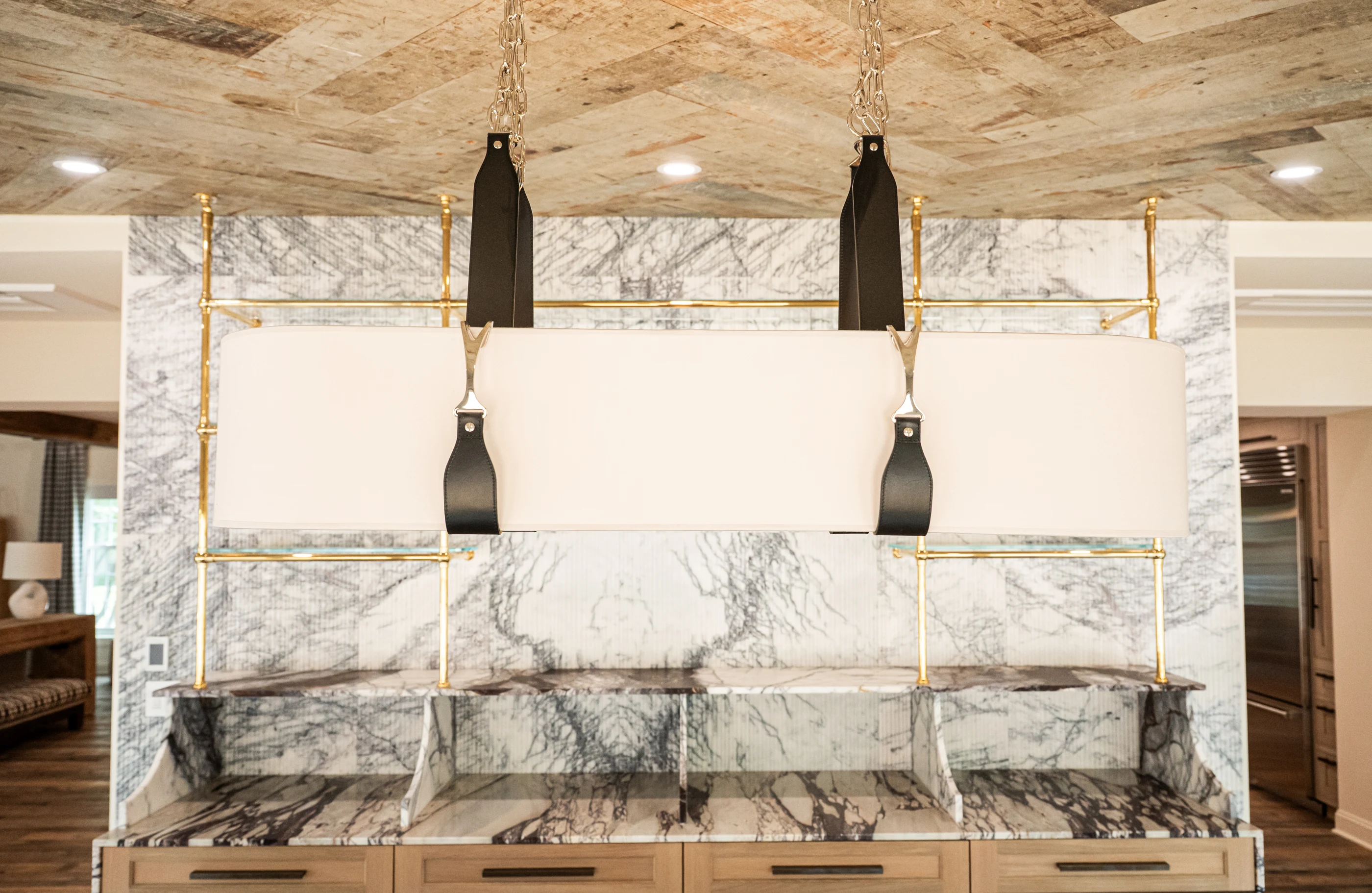Pendant lighting against the veined stone wall at Hart Townhouse.