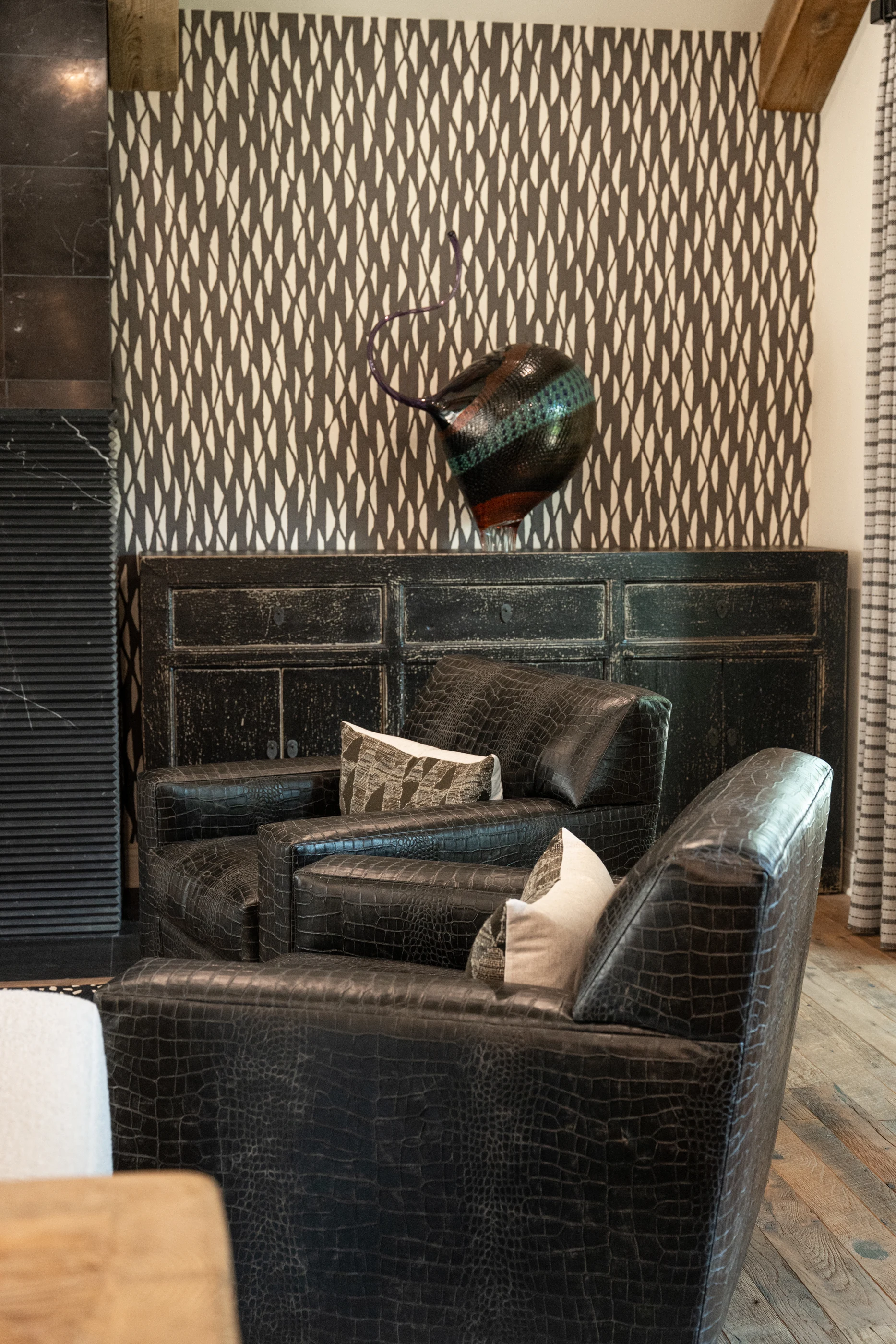 Patterned chairs against dark paneling at Hart Townhouse.