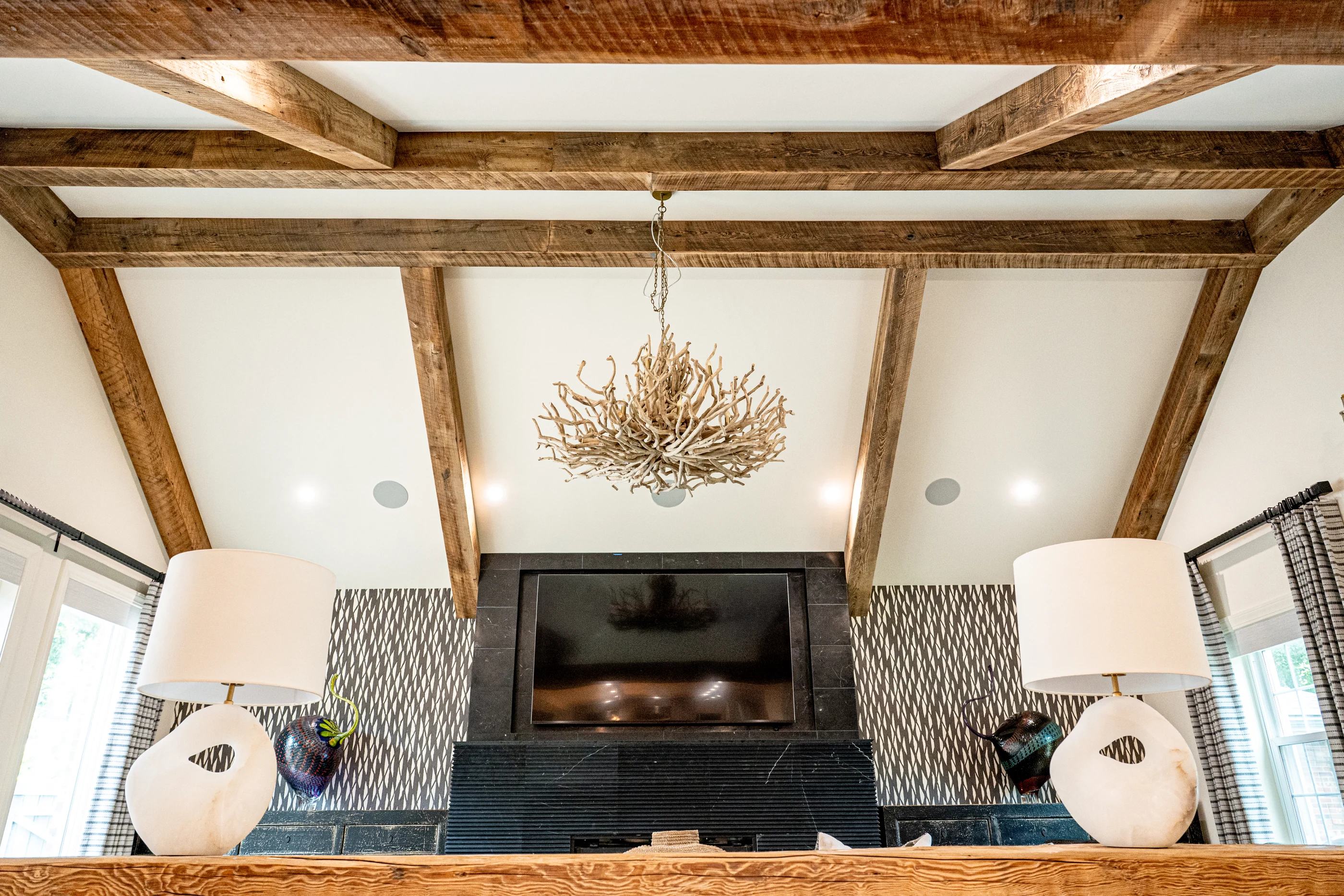 Living room with exposed timber ceiling beams at Hart Townhouse.