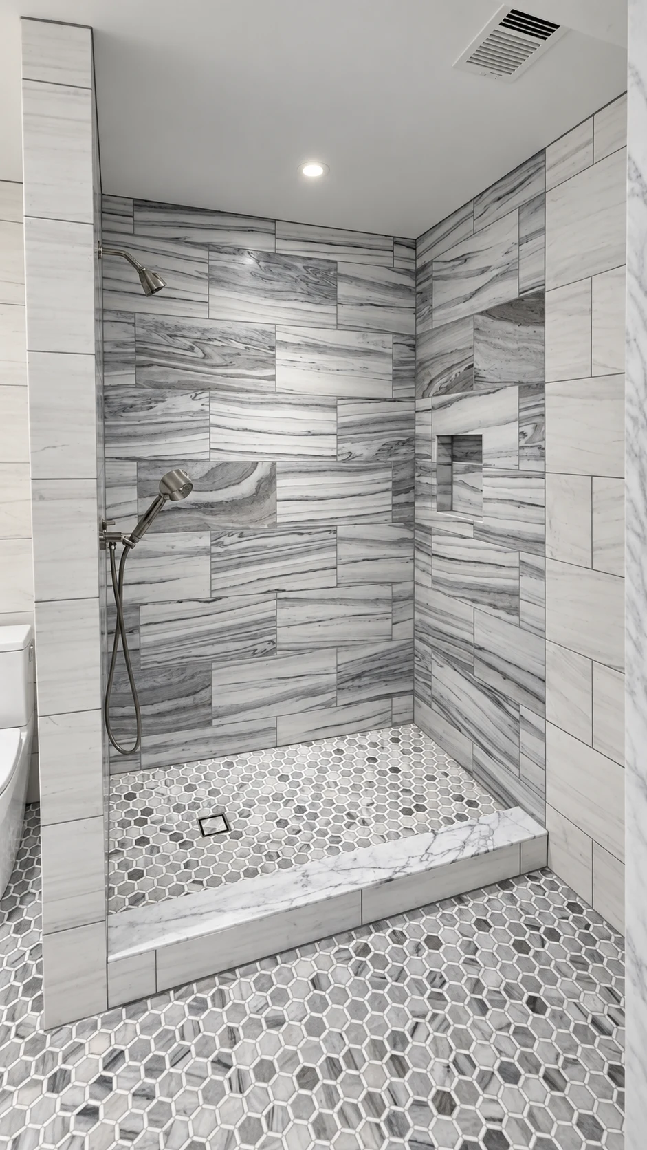 Veined marble shower and carefully detailed fixtures at Lakeside.