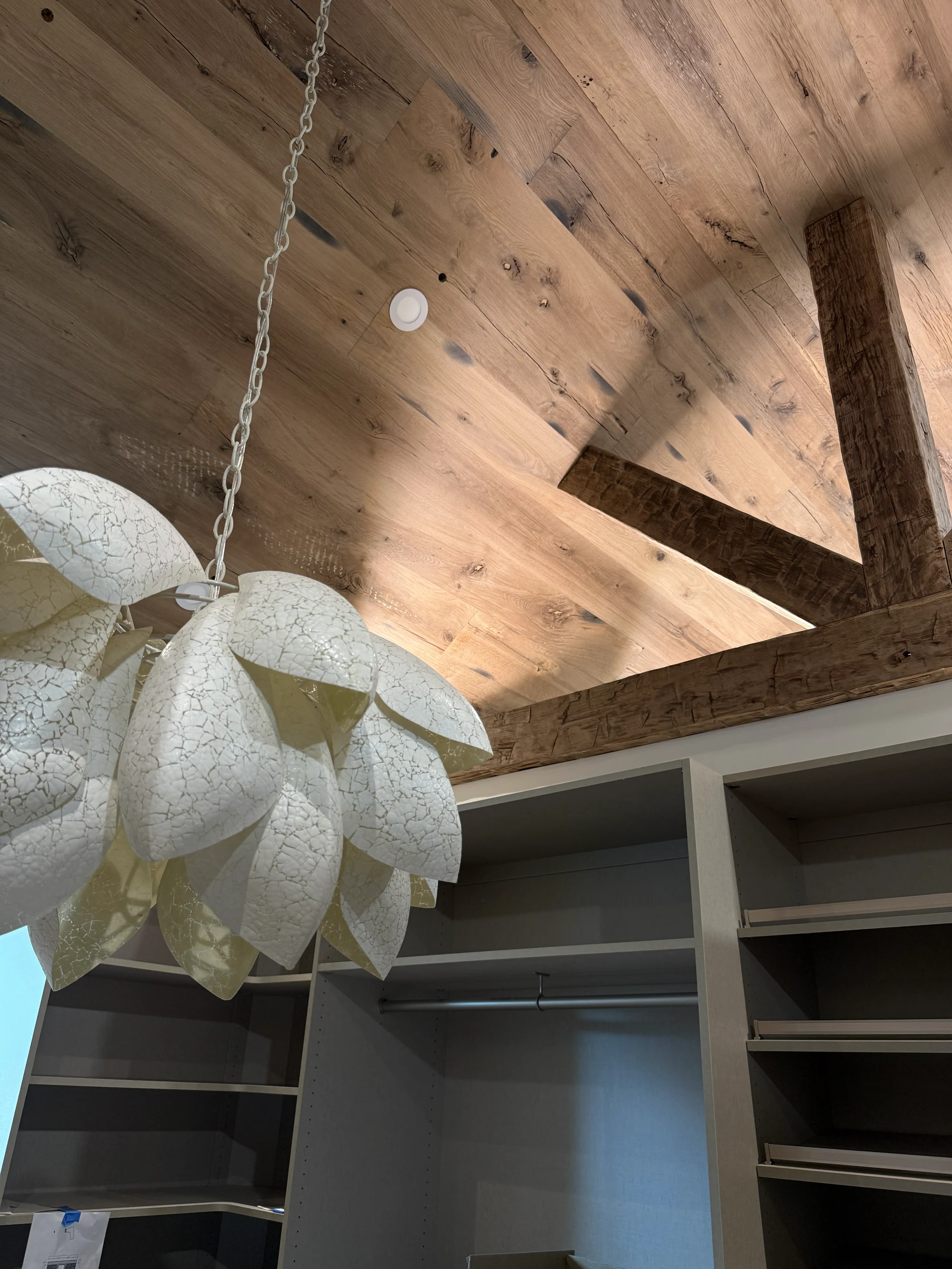 Sculptural white petal pendant beneath a timber ceiling at Hart.