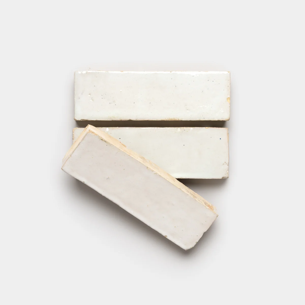 Three white glazed tile samples