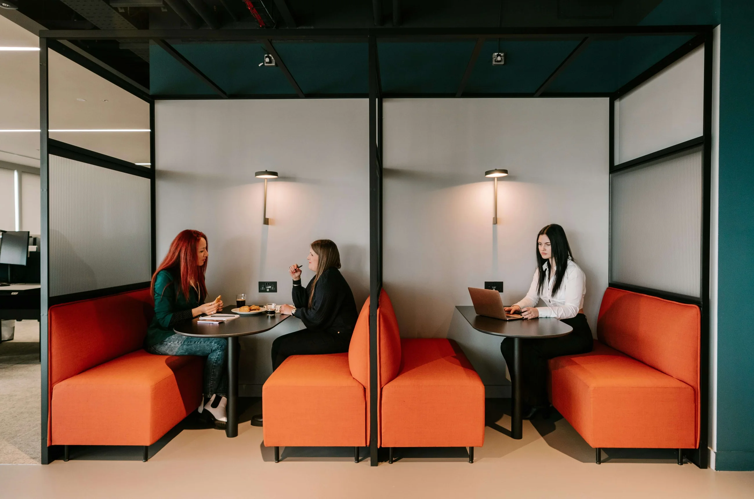 Two people in a booth, mid-conversation