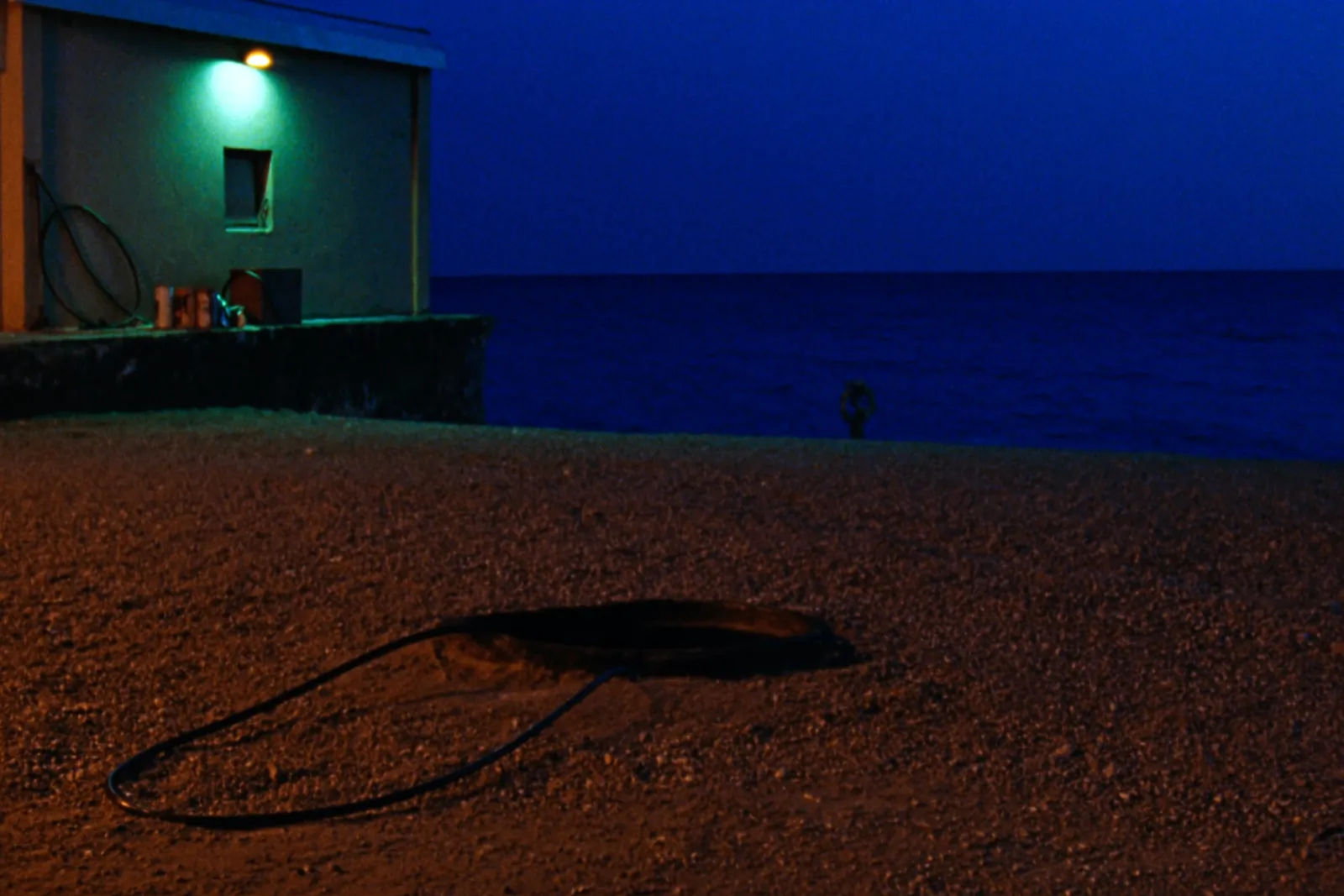 Cable landing station on a quiet coast at dusk on the Ligurian shore near Genoa
