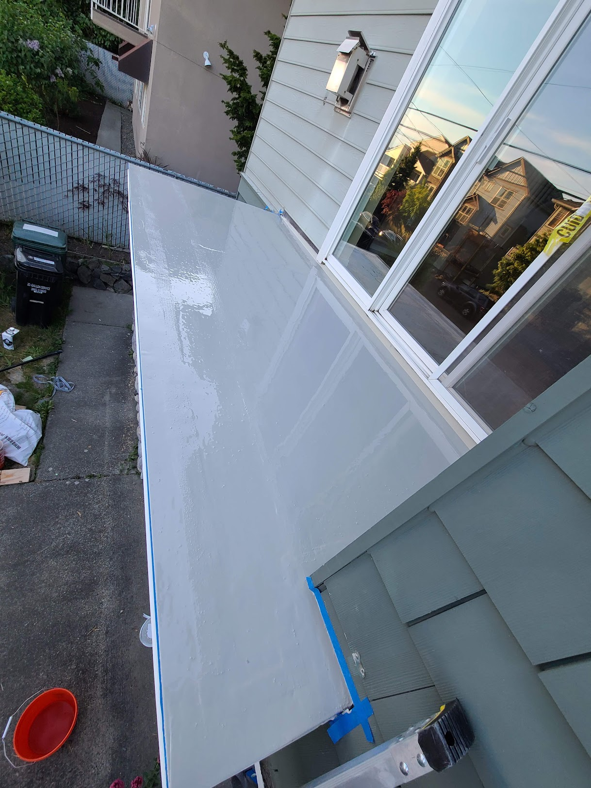 Repaired balcony floor with a clean, freshly sealed grey waterproof coating.