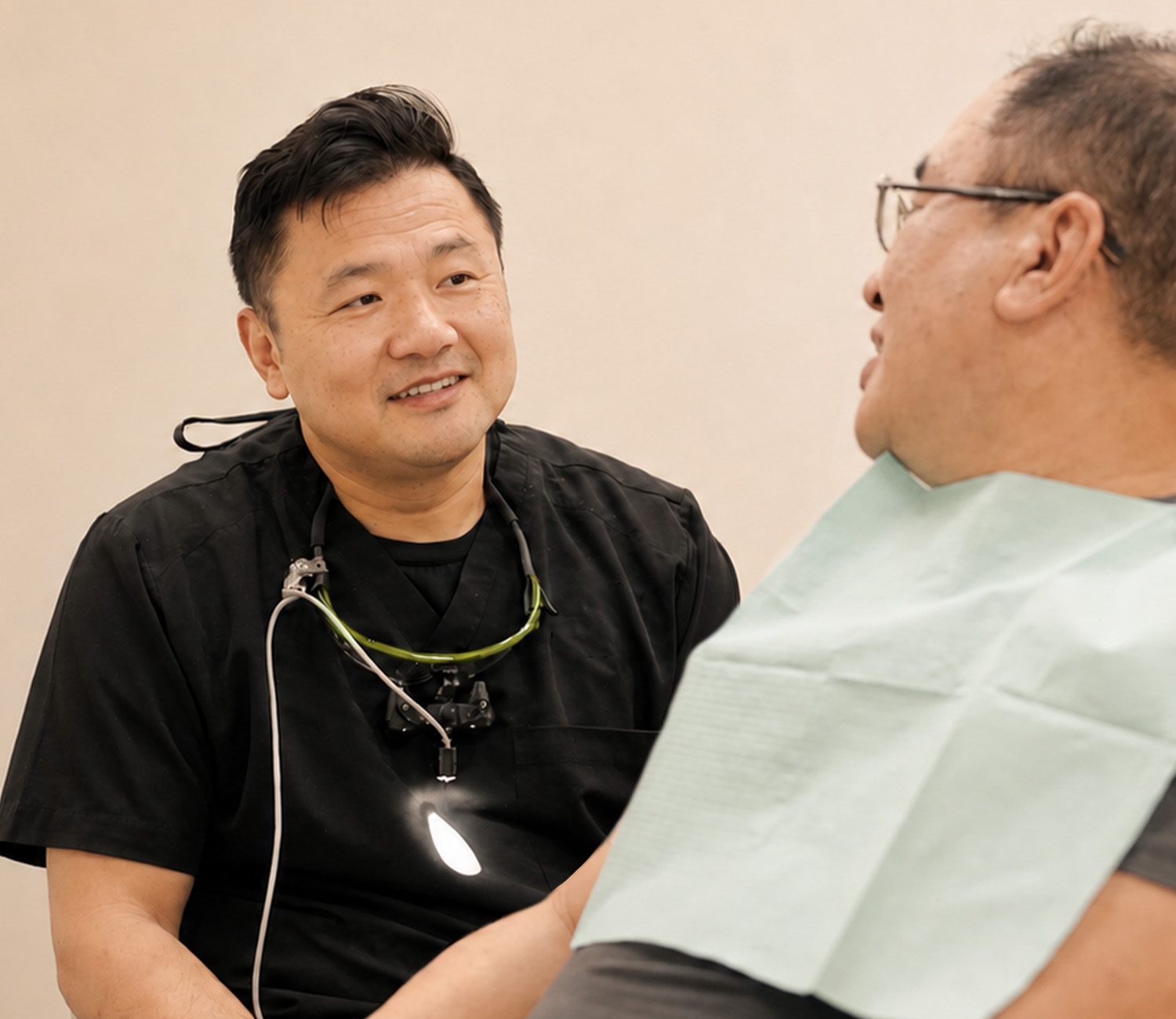 Dr. John Hao Rong, Saratoga dentist, talking with a patient during a visit