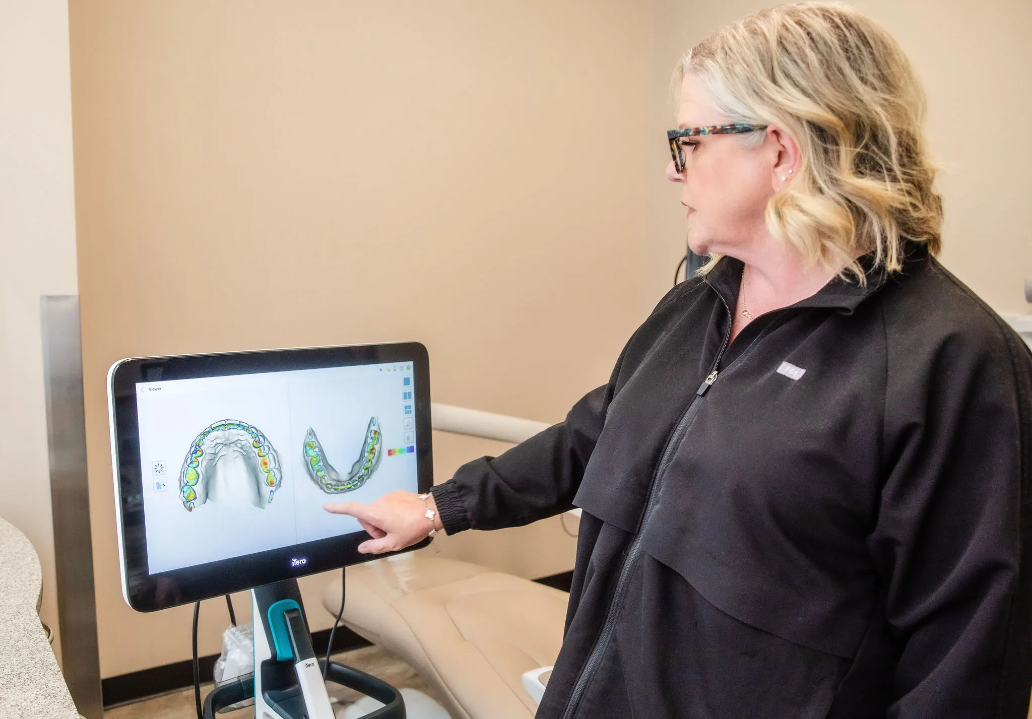 Clinician pointing at an intraoral scan on a monitor