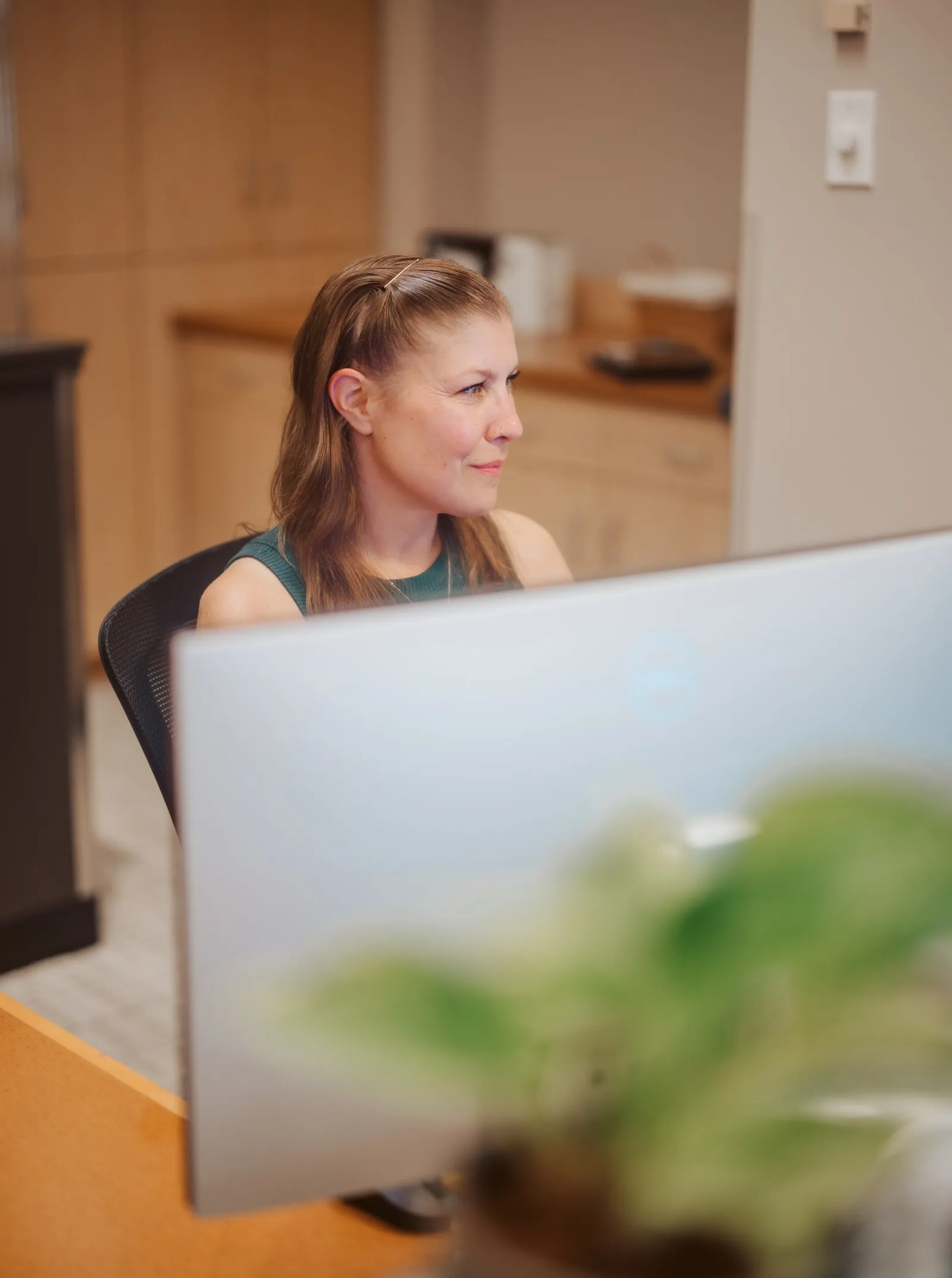 Team member reviewing information on a computer at J & D Dental