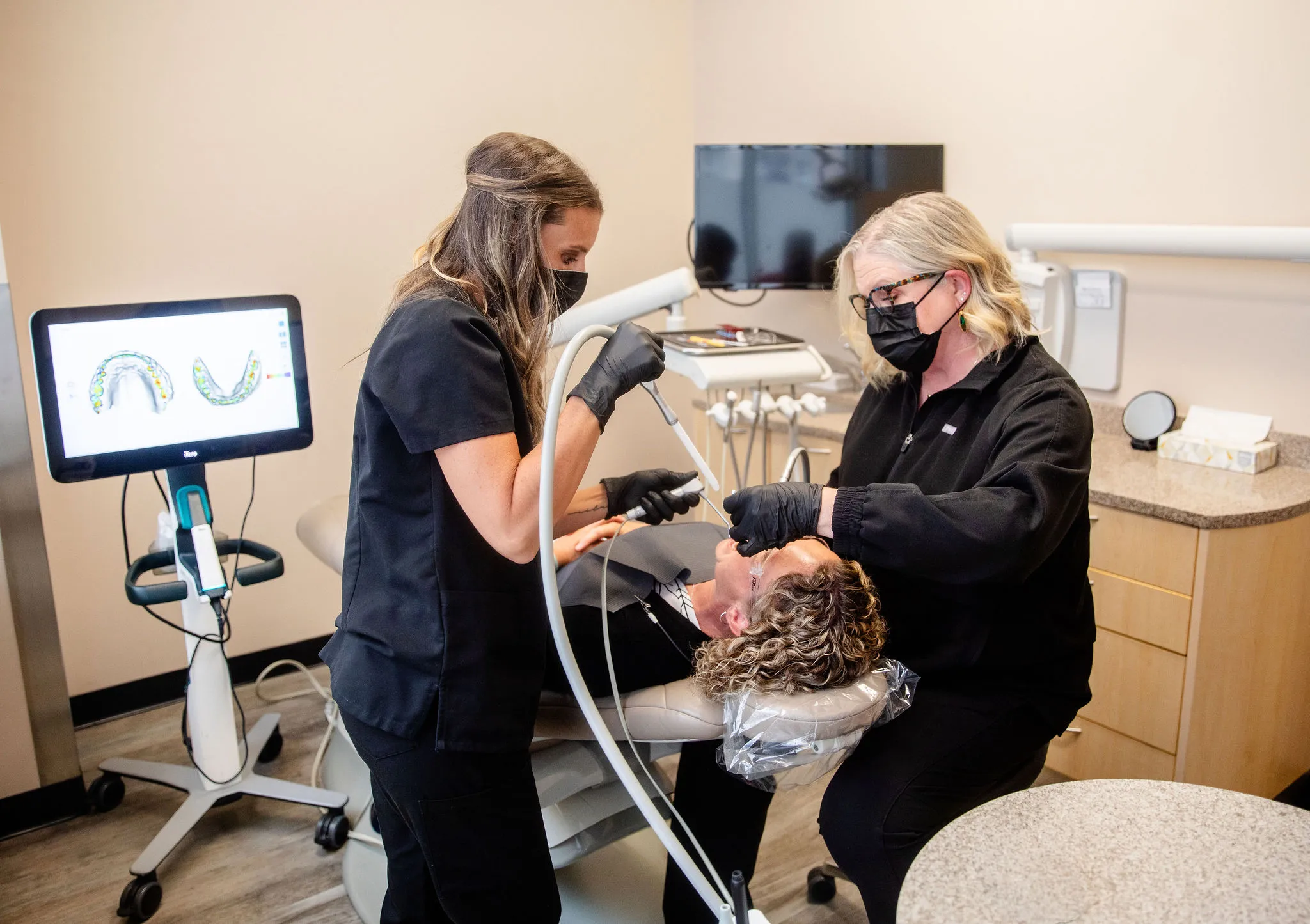 Dr. Herbert and a team member using a digital scanner during a patient visit.