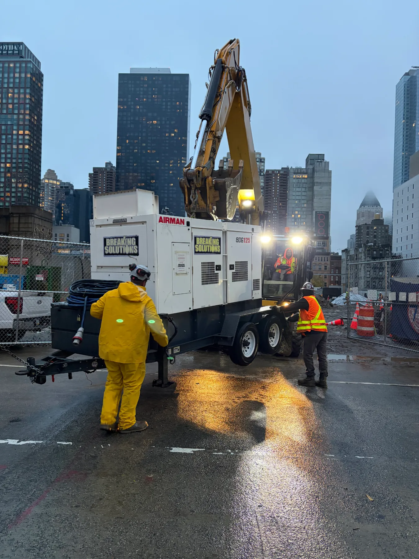BSI crew setting a clean Airman generator on a Manhattan job site at dawn