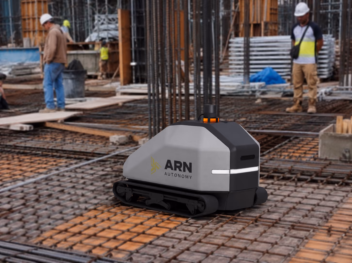 GRID on a rebar mat at an active construction site, with workers in the background.