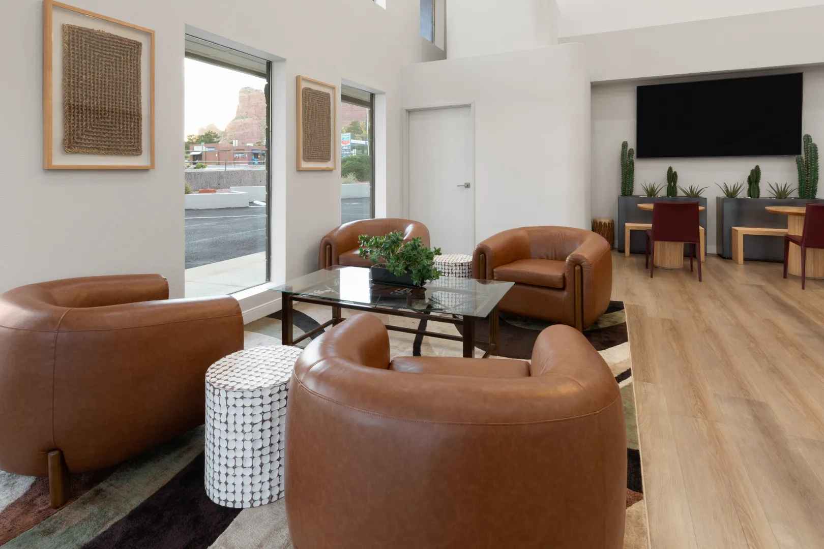 Lobby lounge with leather chairs and red rock views at Kokopelli Inn Sedona