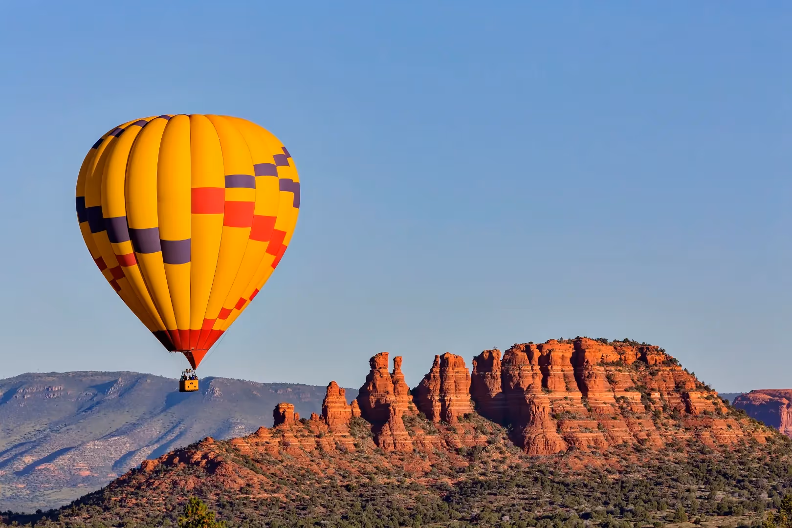 Hot air balloon over Sedona red rock formations