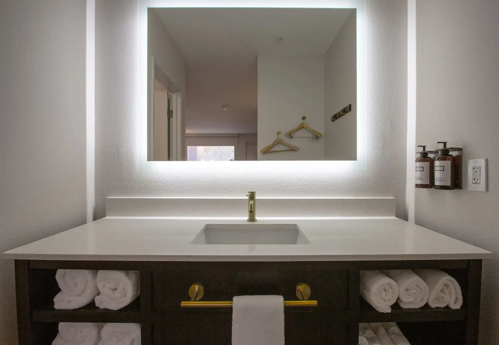 Bathroom vanity in the King Mobility Accessible Room at Kokopelli Inn Sedona with lighted mirror