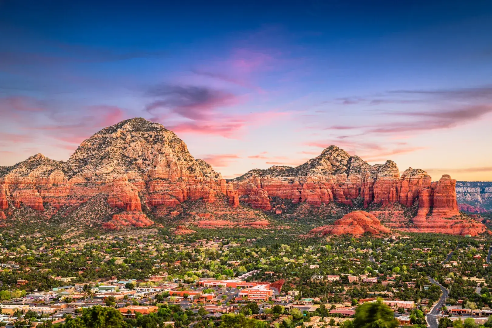 Sedona town and red rock cliffs at dusk