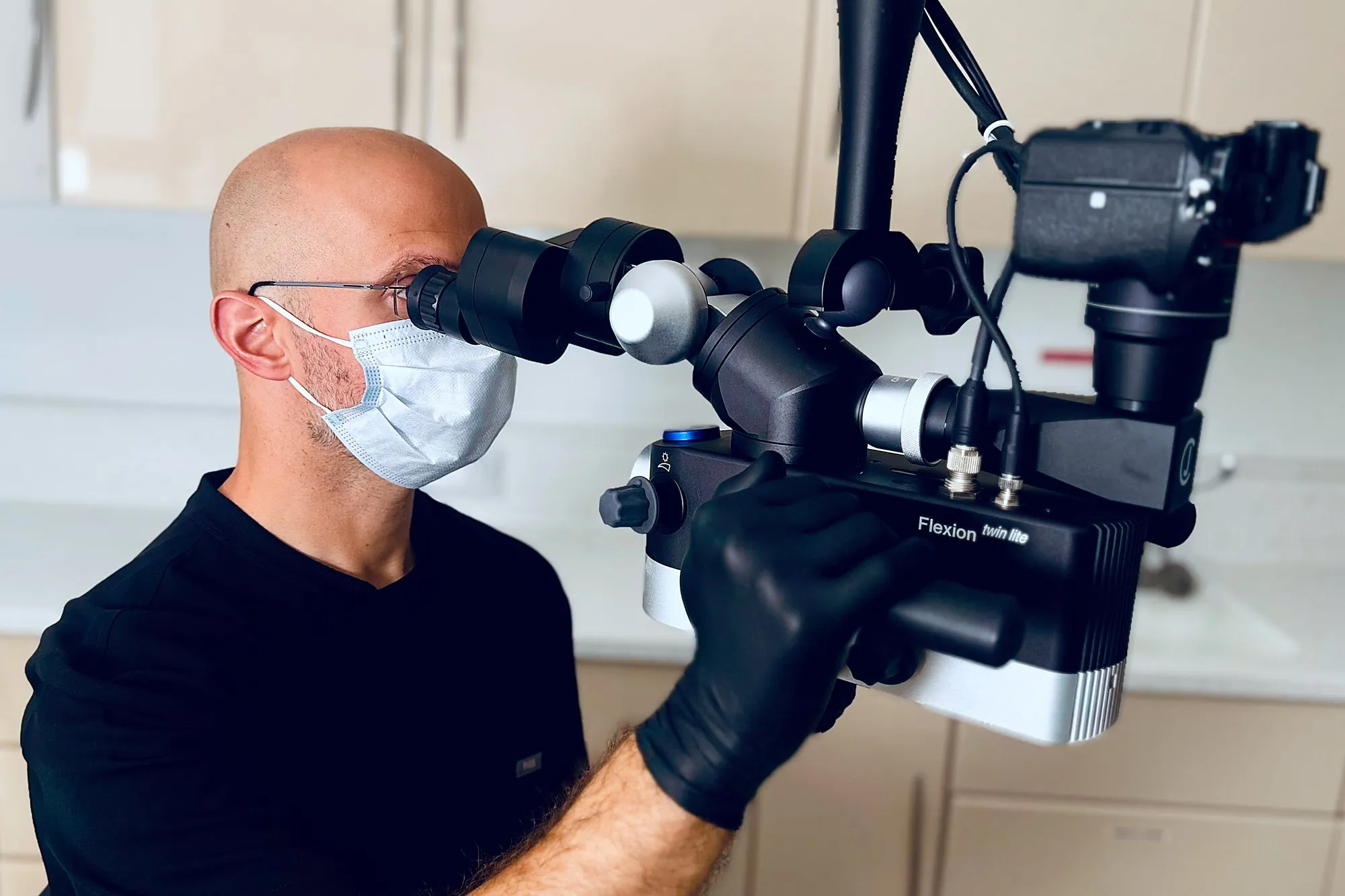 Spencer Richman carrying out root canal treatment under a dental operating microscope