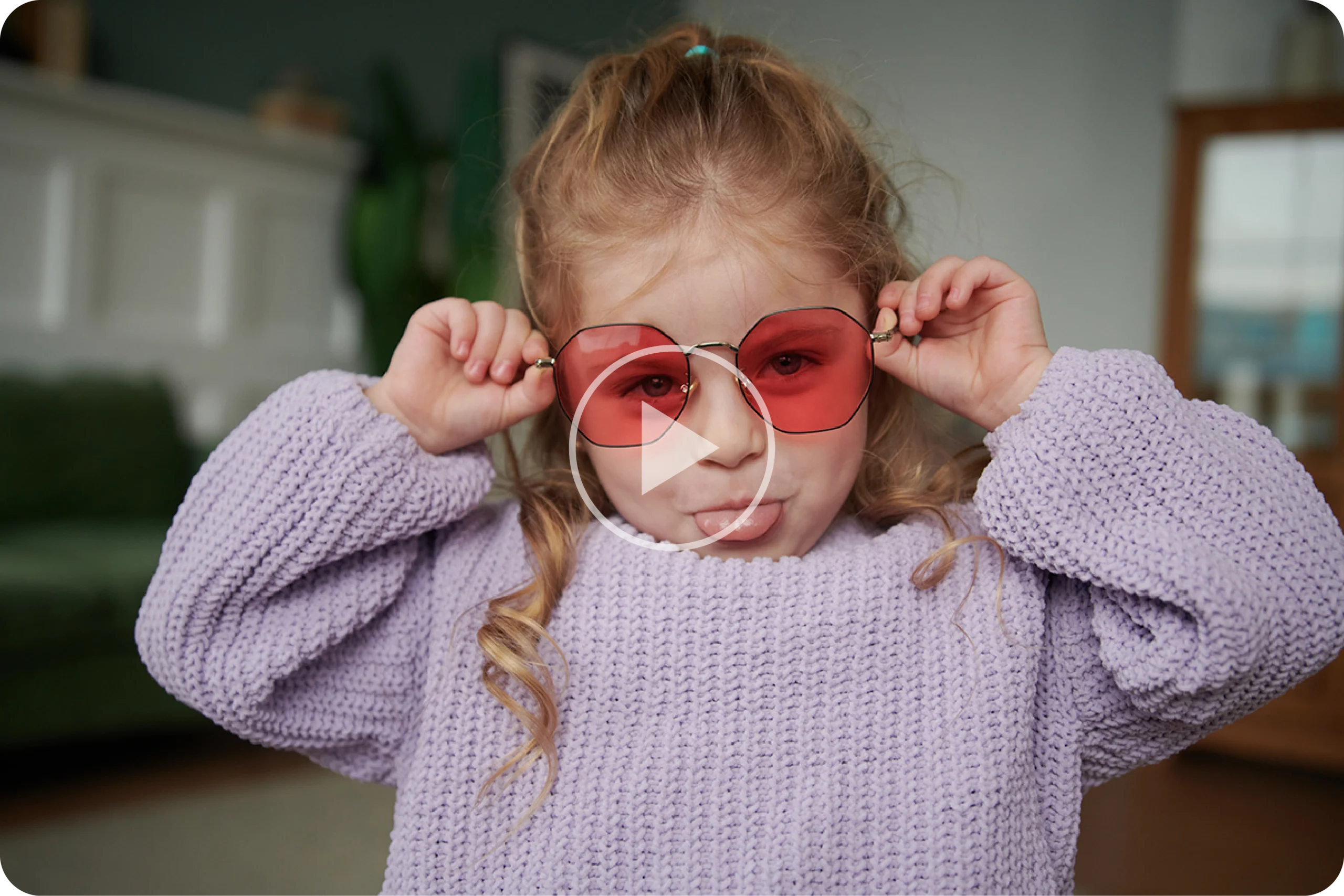 Young girl in pink sunglasses pulling a face