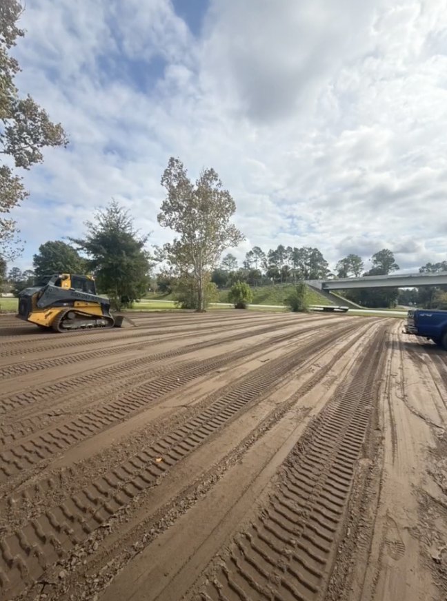 Tracked dozer grading a level dirt pad in Gulf County, Florida