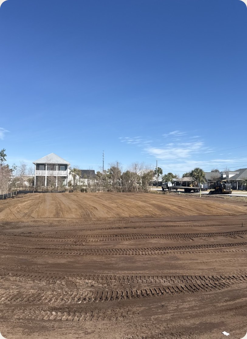 Leveled building lot with neighboring homes behind